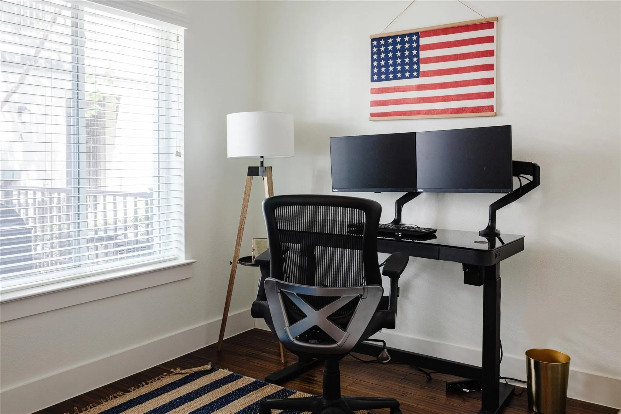 Crisp white walls with dark wood-finish flooring provide a neutral backdrop