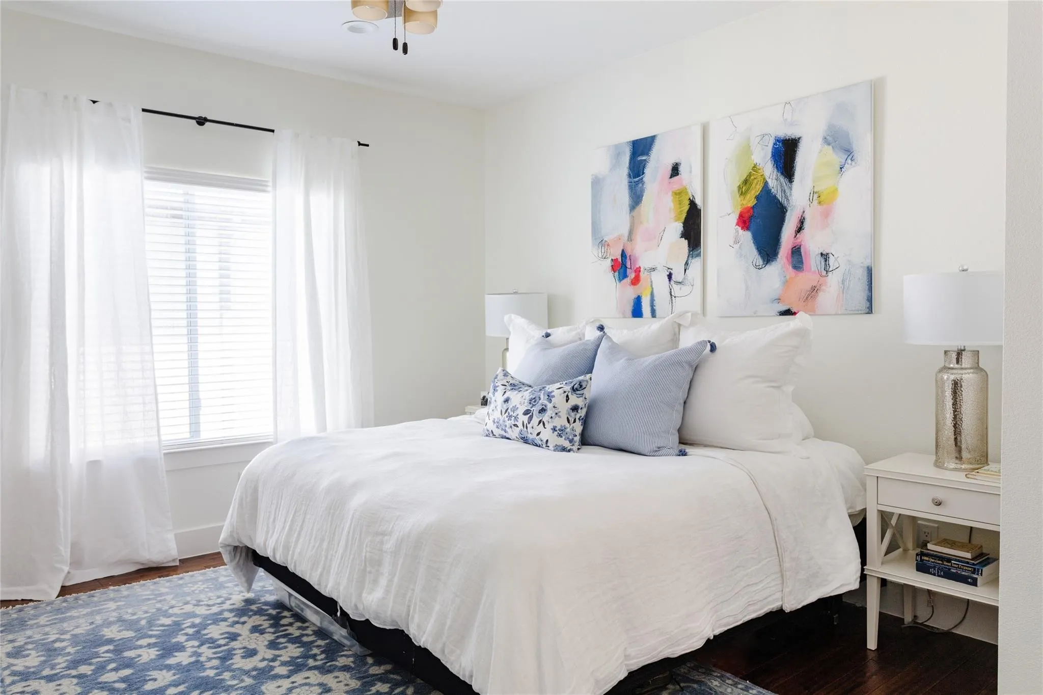 Hardwood-finish flooring features a decorative area rug