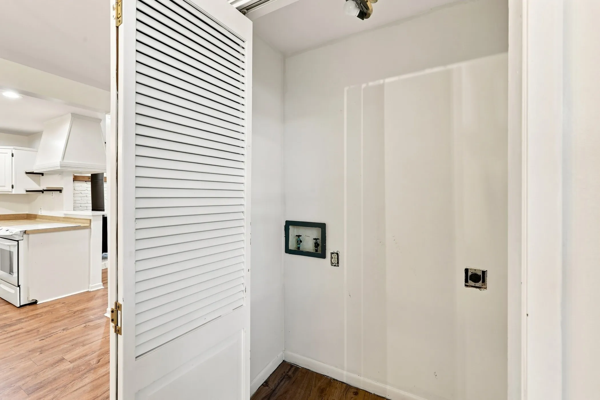 Dedicated utility area featuring hookups for laundry appliances