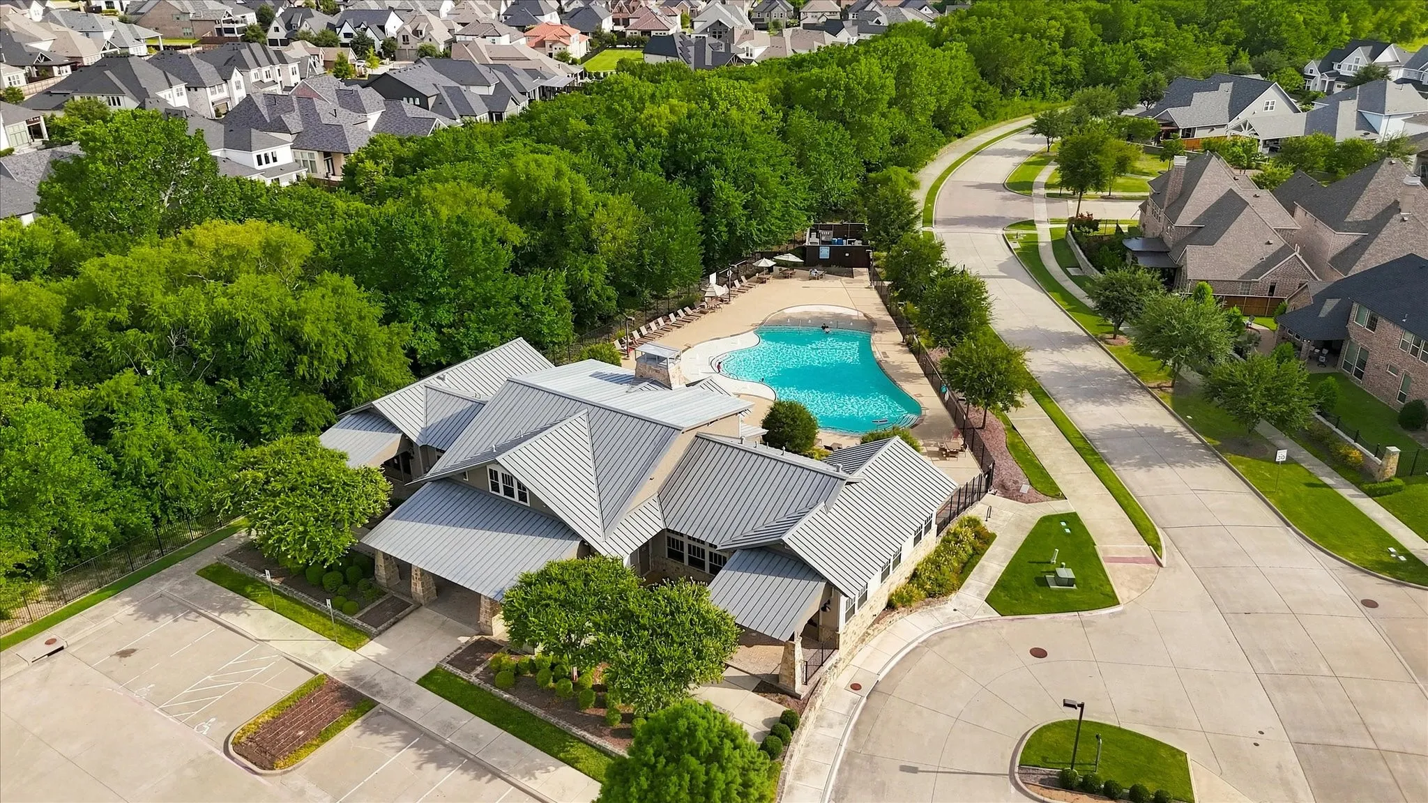 Community clubhouse with a metal roof and an outdoor swimming pool