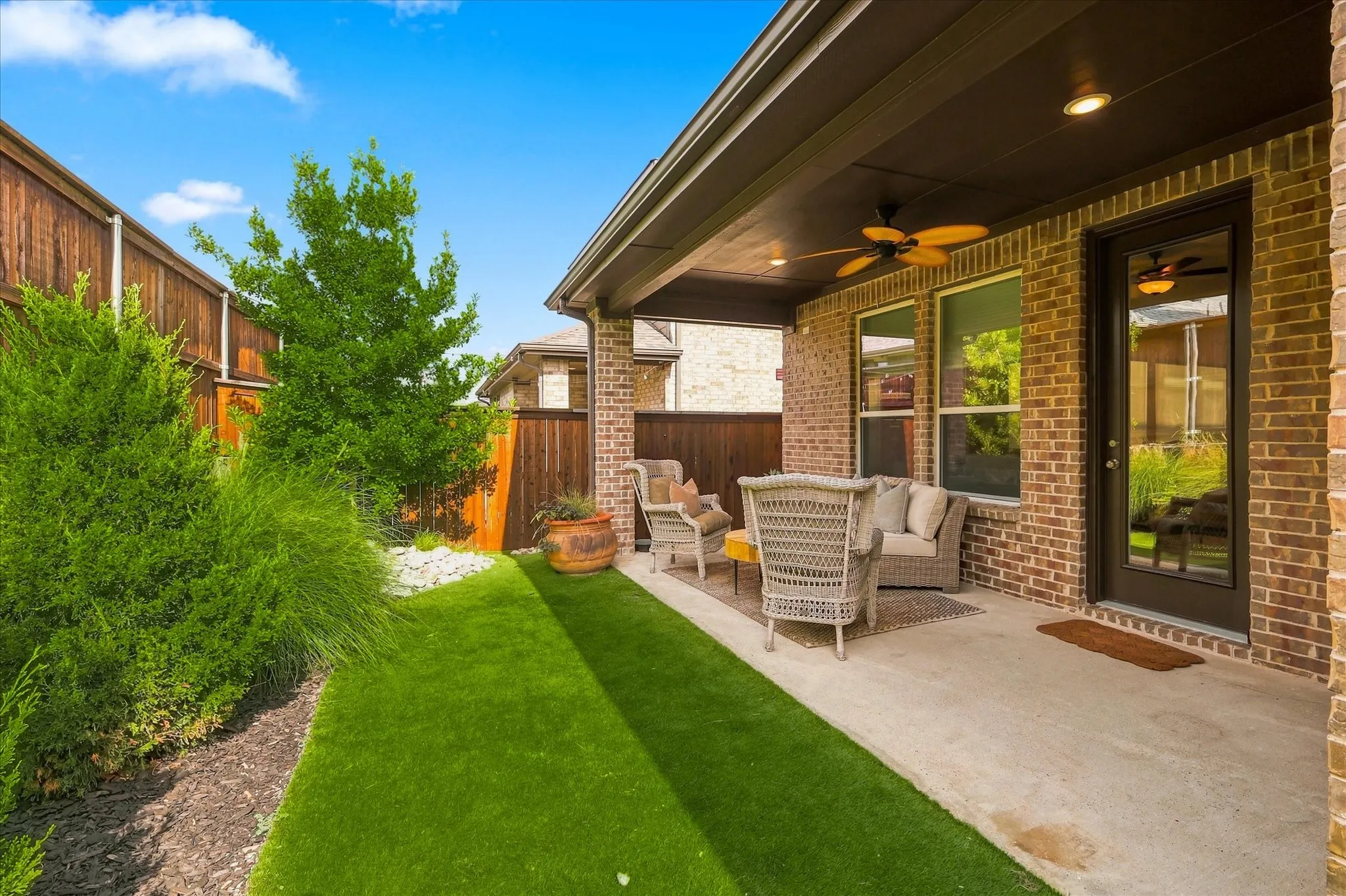 Covered patio with recessed lighting, ceiling fan, and brick exterior