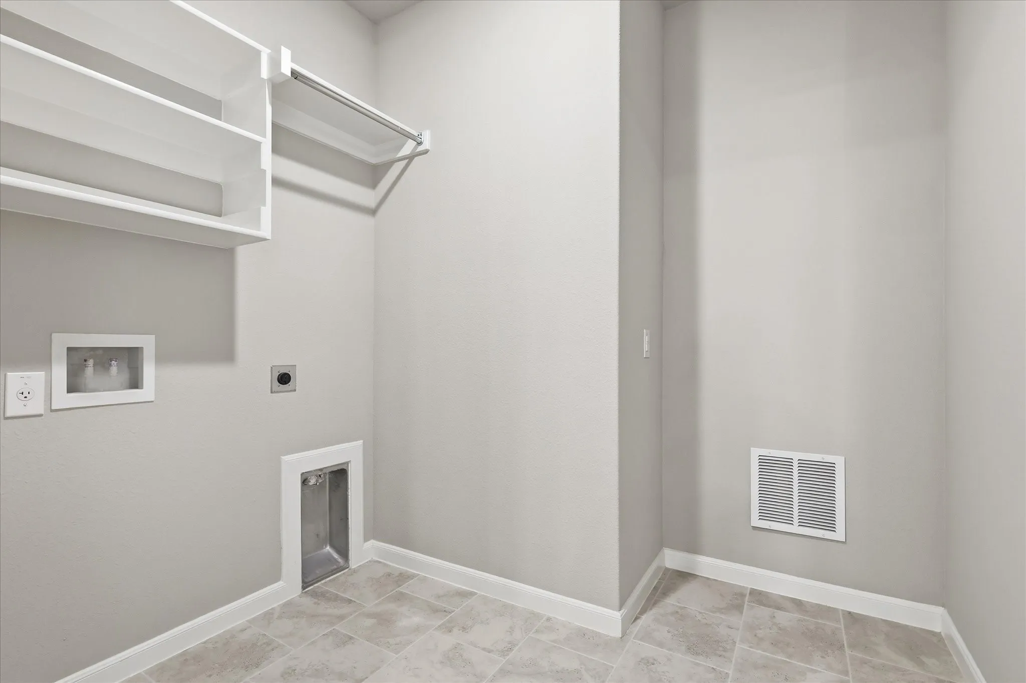 Built-in shelving, hanging rod, and light-toned tile flooring