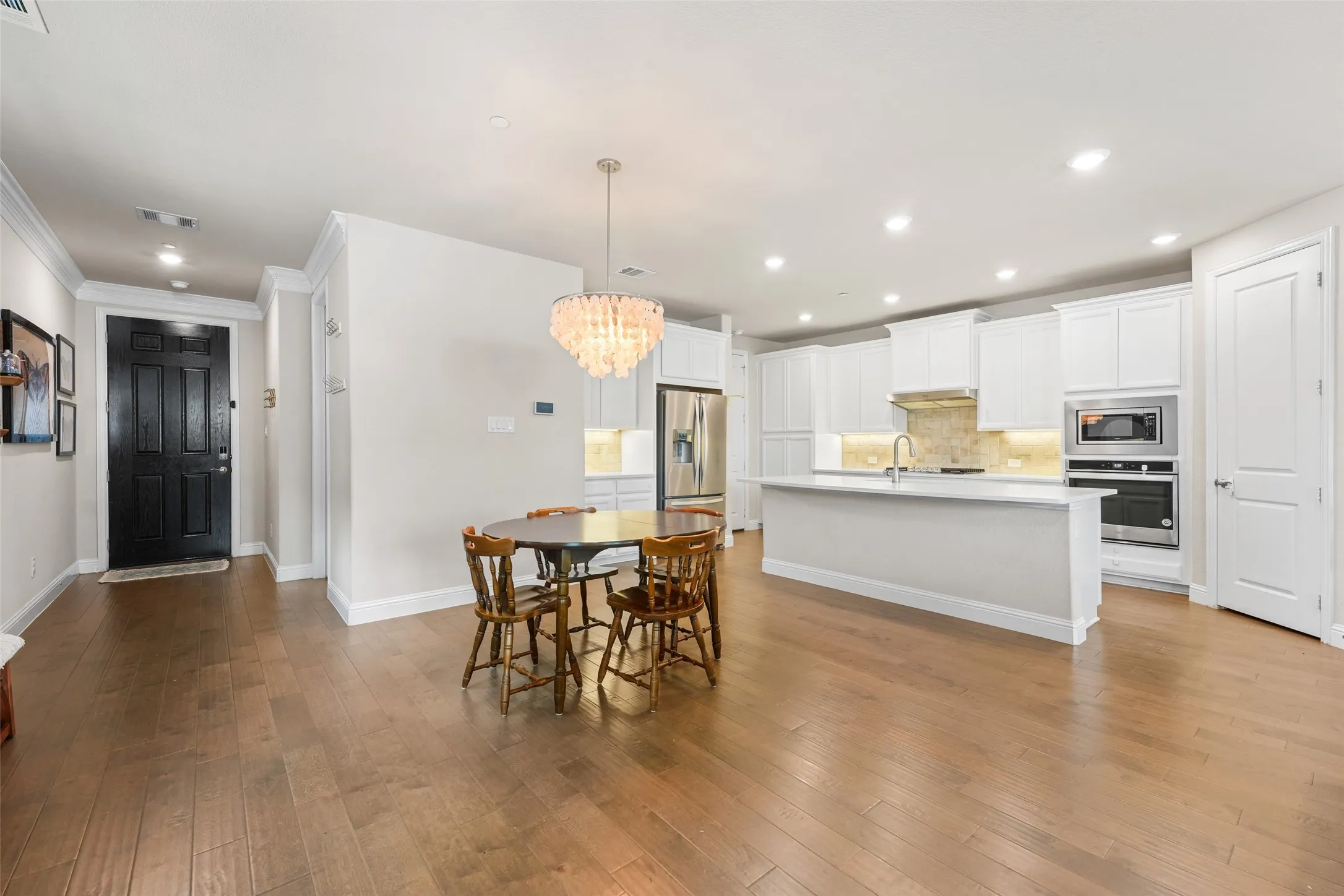 Open-concept main living area featuring wood-finish flooring throughout