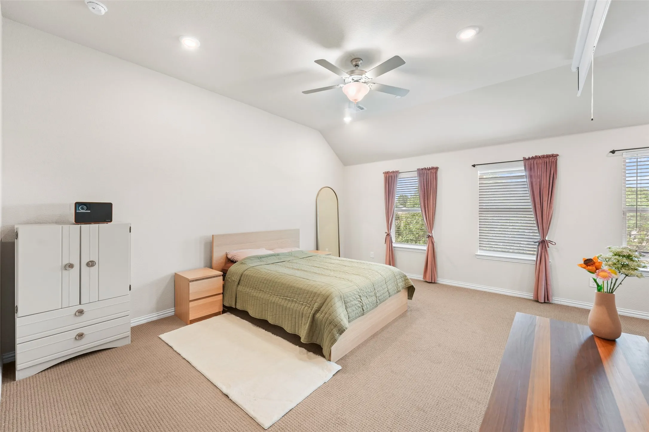 Spacious room with a vaulted ceiling, recessed lighting, and a ceiling fan