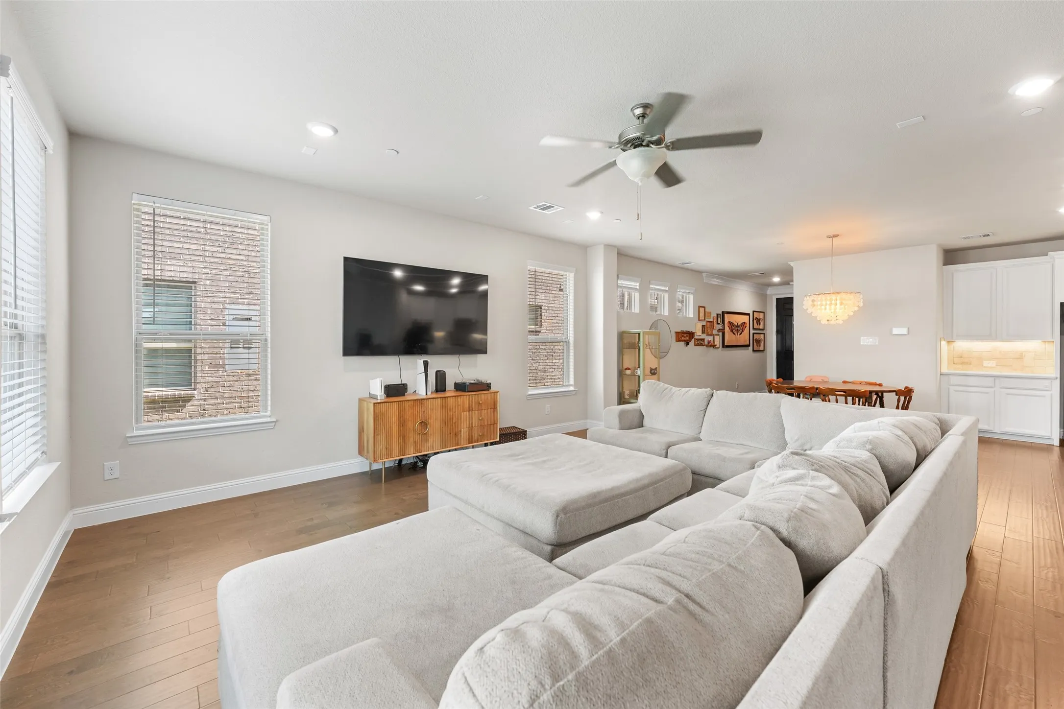 Open-concept living space with wood-finish flooring