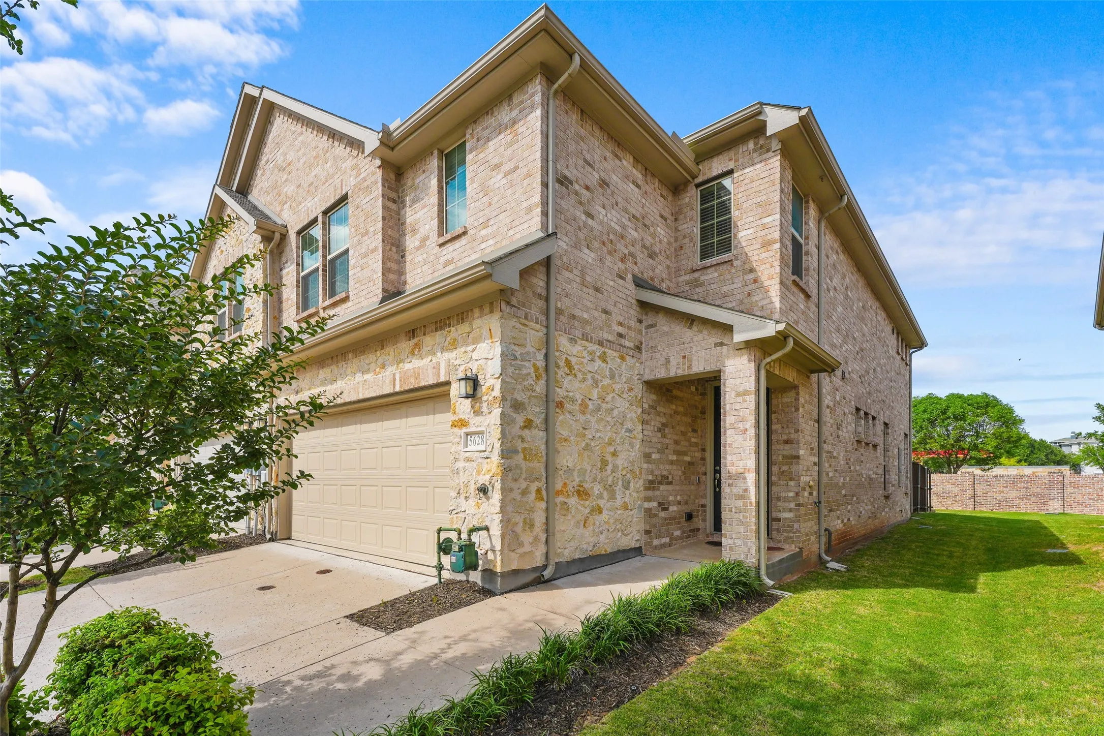 Brick and stone veneer exterior with a two-car garage