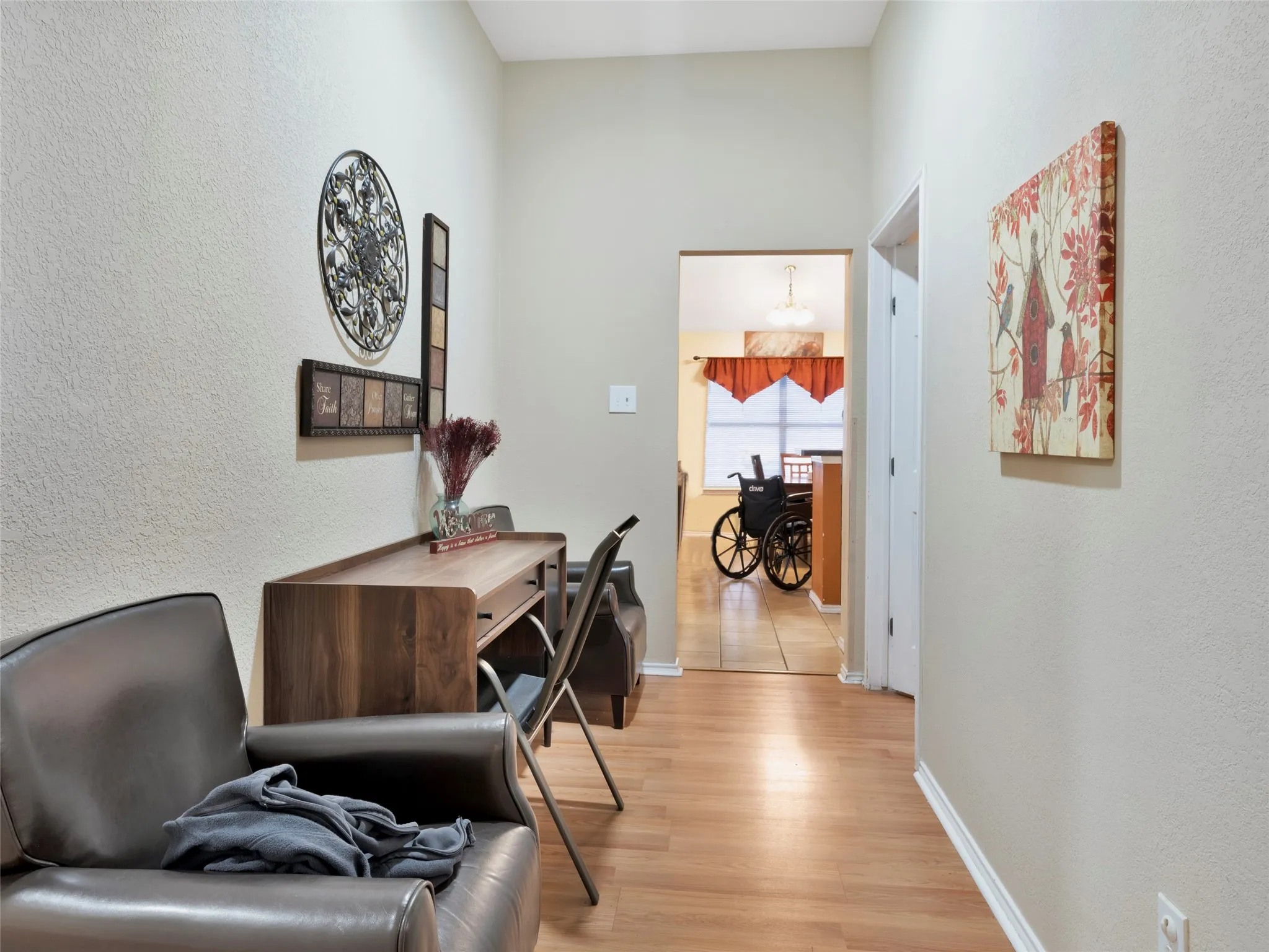 Hallway featuring wood-finish flooring and neutral wall tones