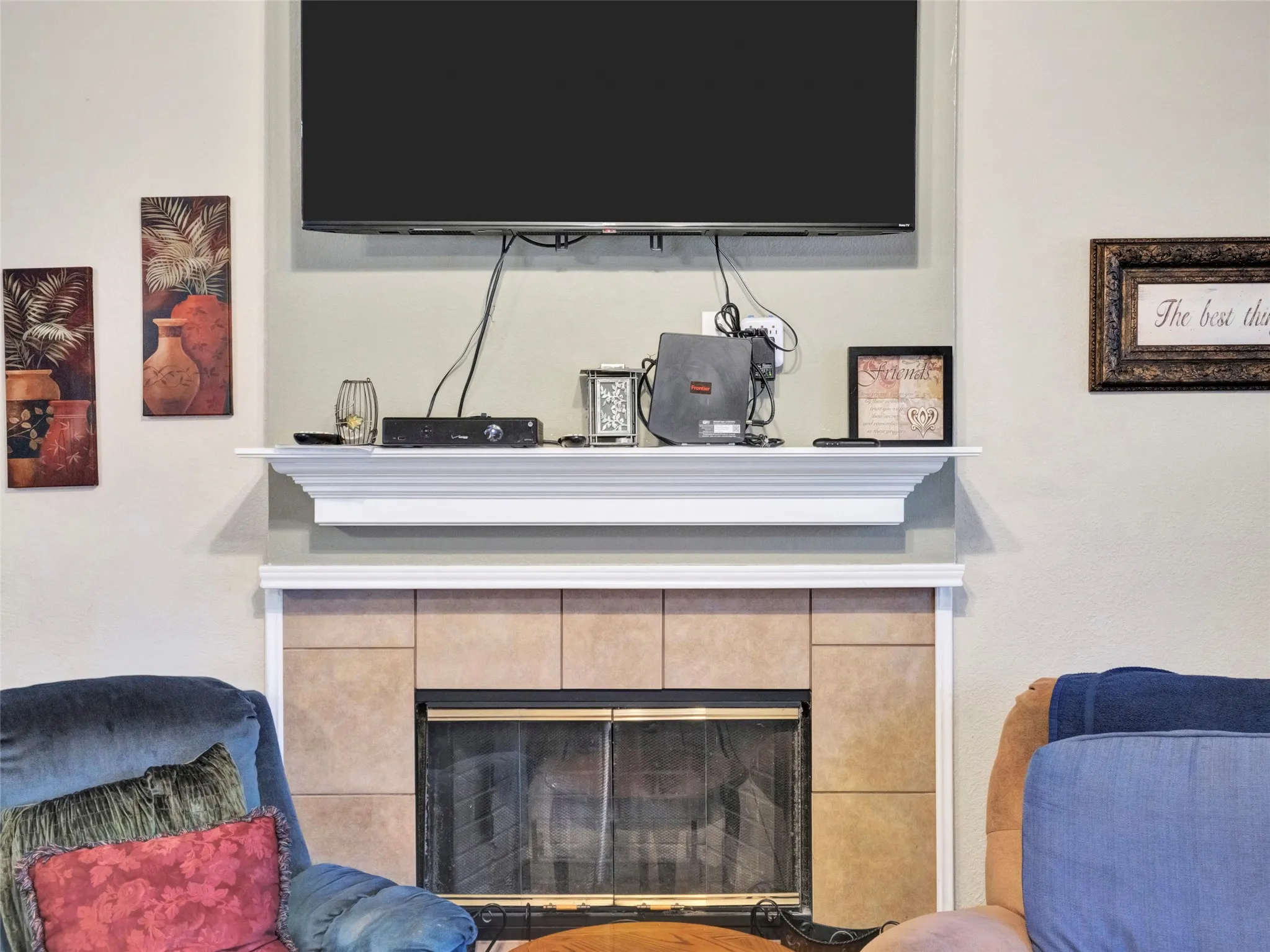 Fireplace with tile surround, white mantel, and glass doors