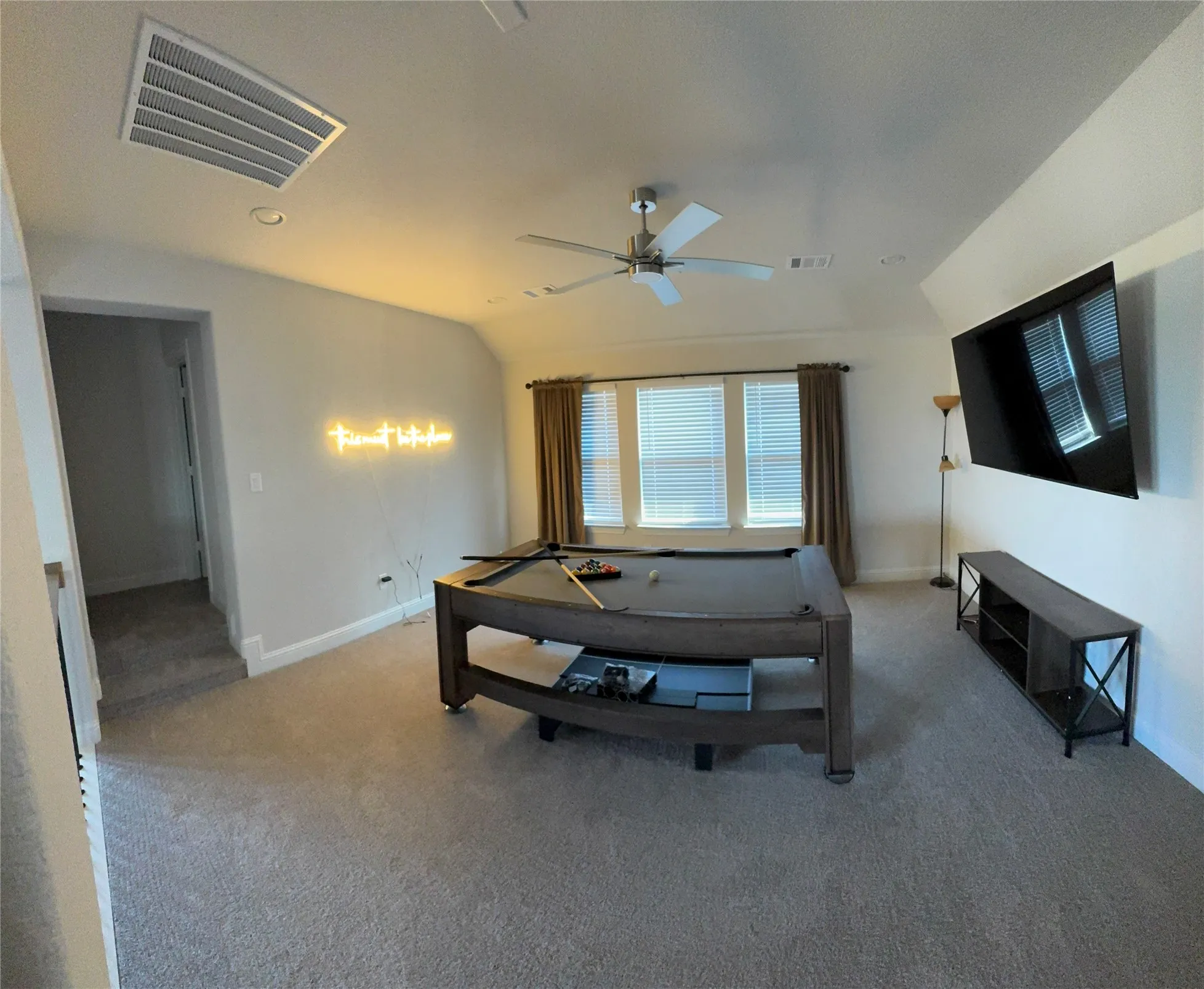 Spacious bonus room featuring vaulted ceilings, recessed lighting, ceiling fan, and carpet flooring