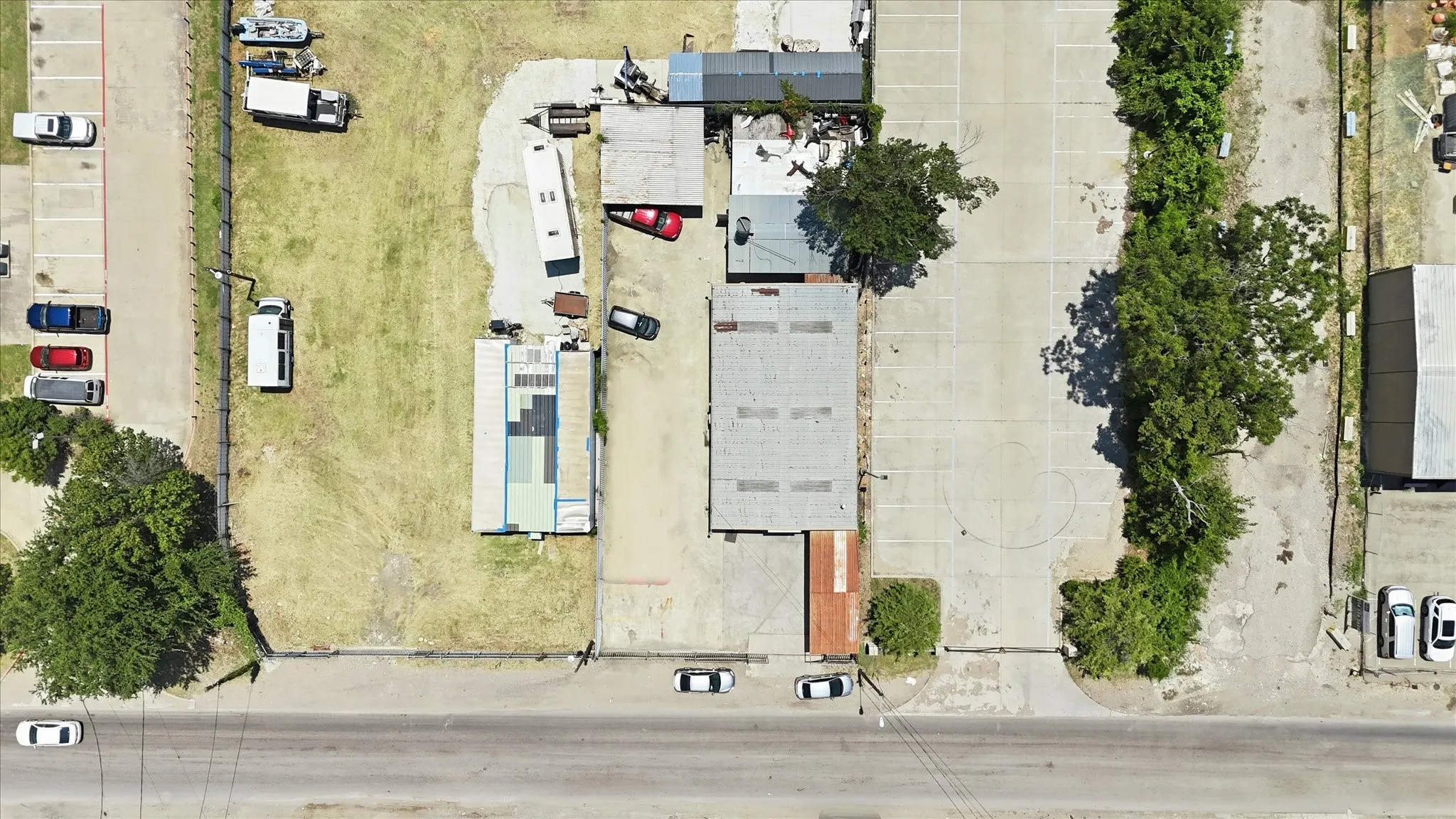 Expansive commercial property featuring a combination of paved and grass areas