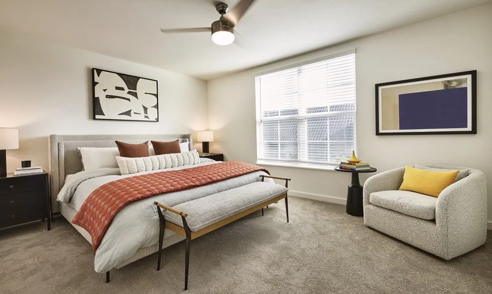 Carpeted bedroom featuring baseboards and ceiling fan