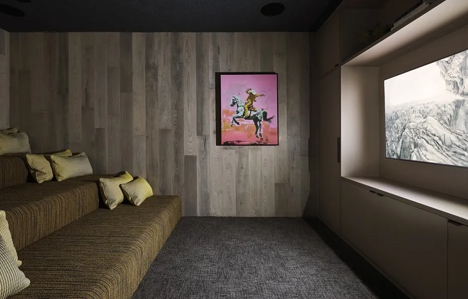 Home theater with carpet floors and wooden walls