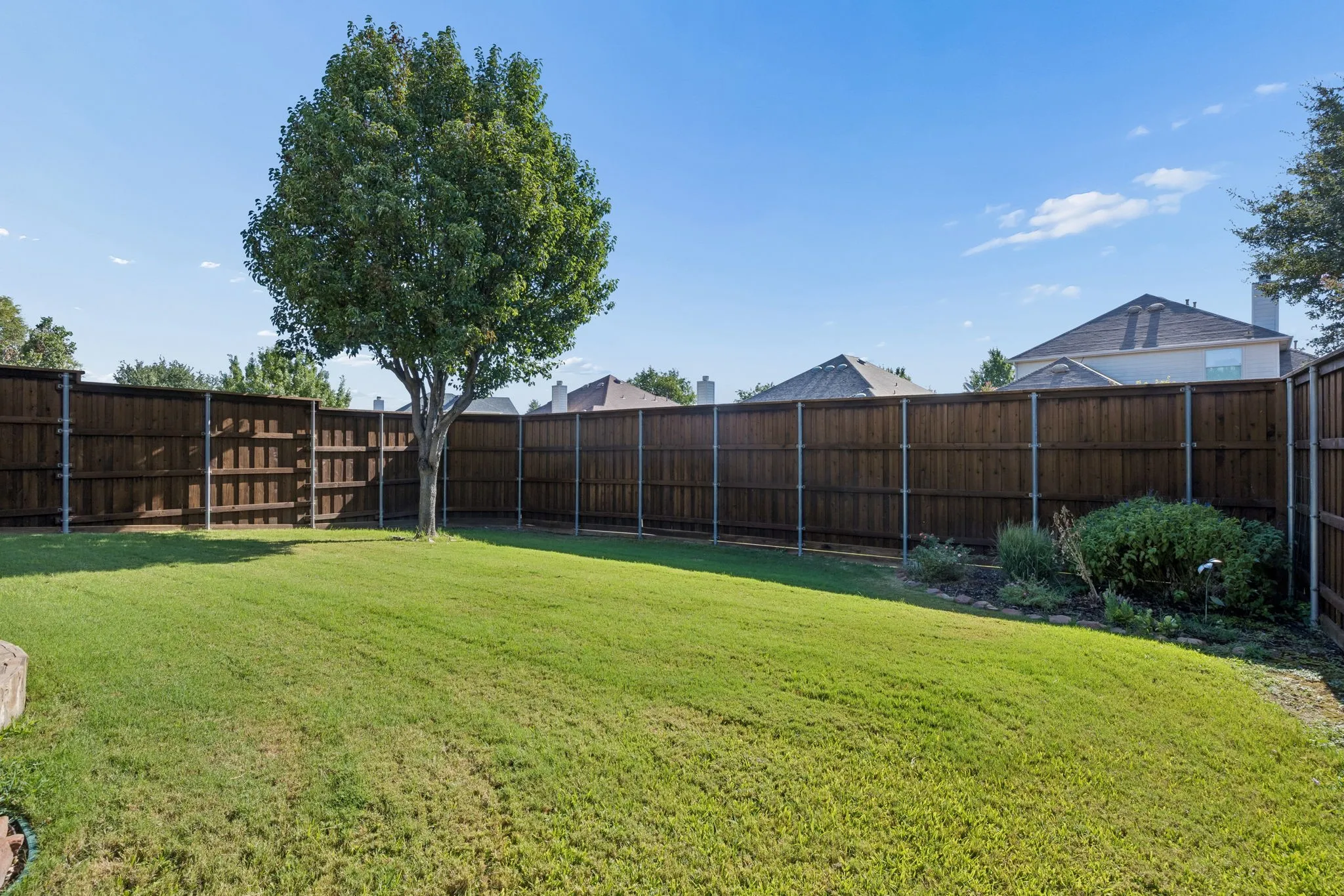 The cedar board-on-board fence was freshly stained in 2026.