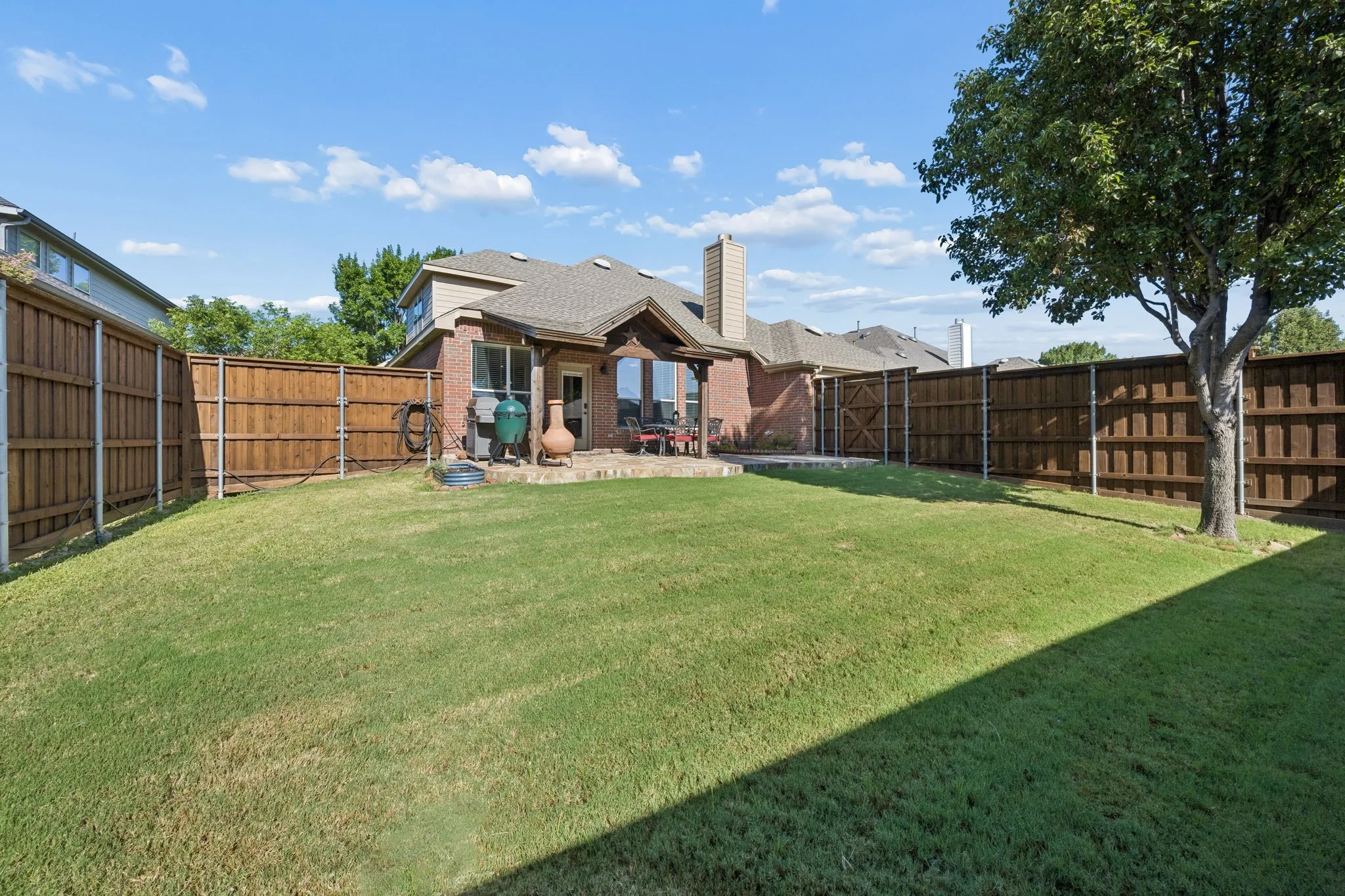 A private, usable backyard with established landscaping and room to gather.
