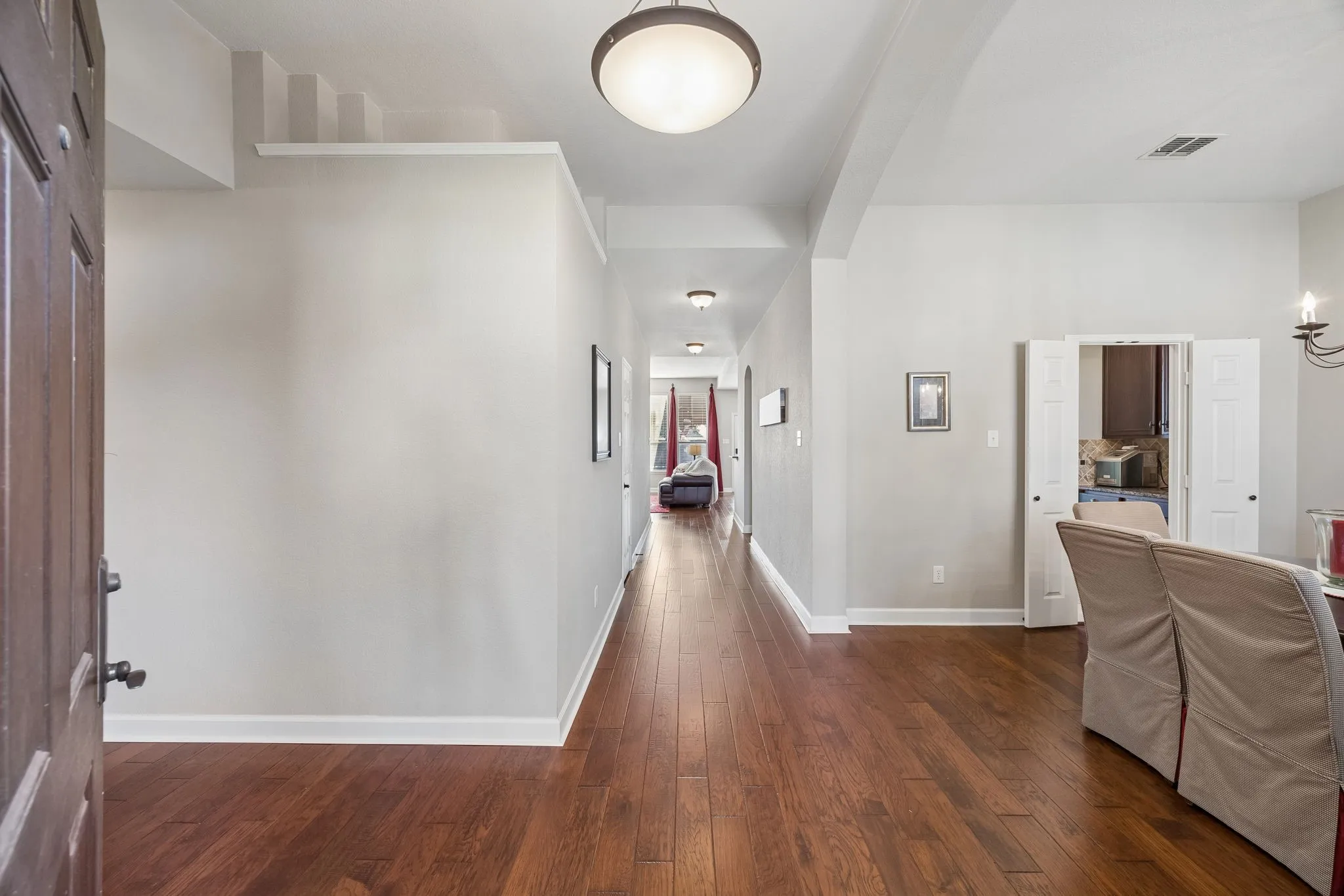 A welcoming entry introduces the home’s warm engineered hardwood flooring.
