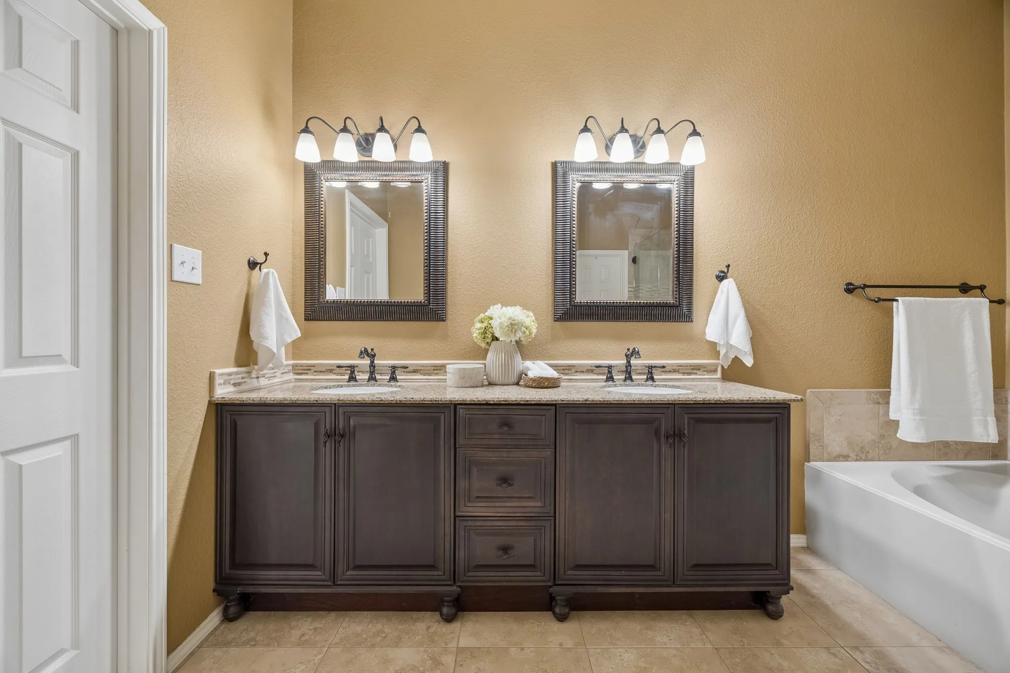 The updated primary bath includes a replaced vanity and granite countertop.