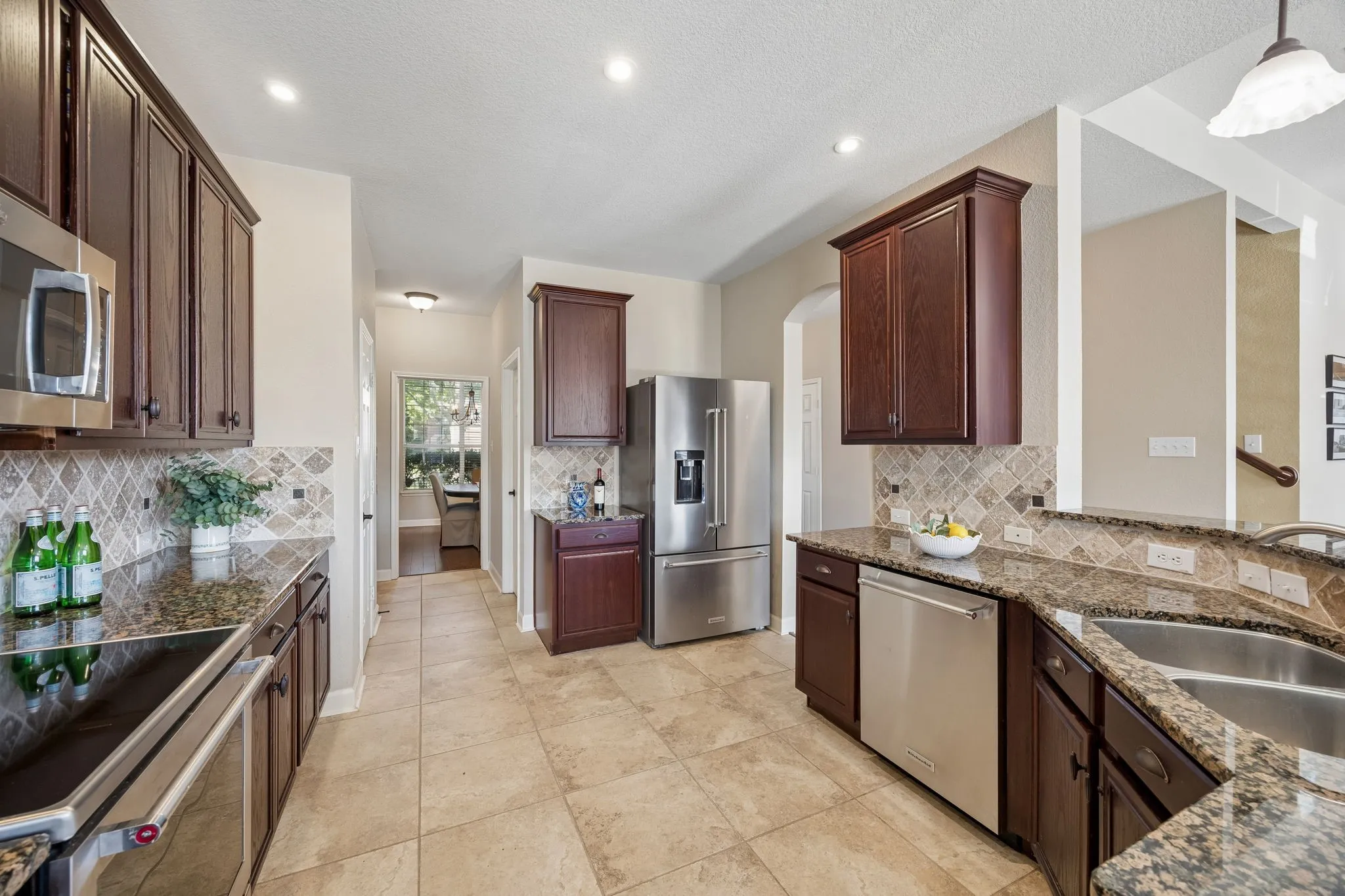 Granite countertops and generous workspace make the kitchen ready for daily life and entertaining.