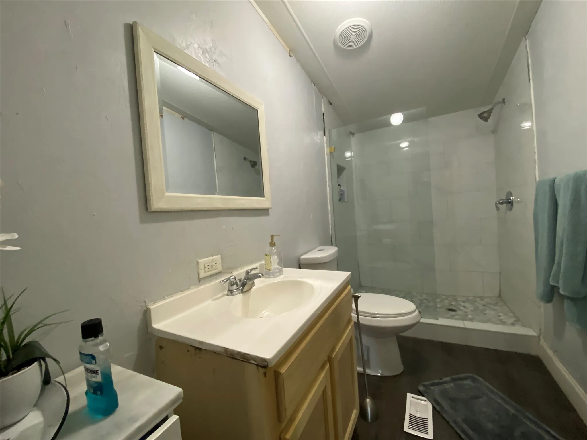 Full bath featuring vanity and a tile shower