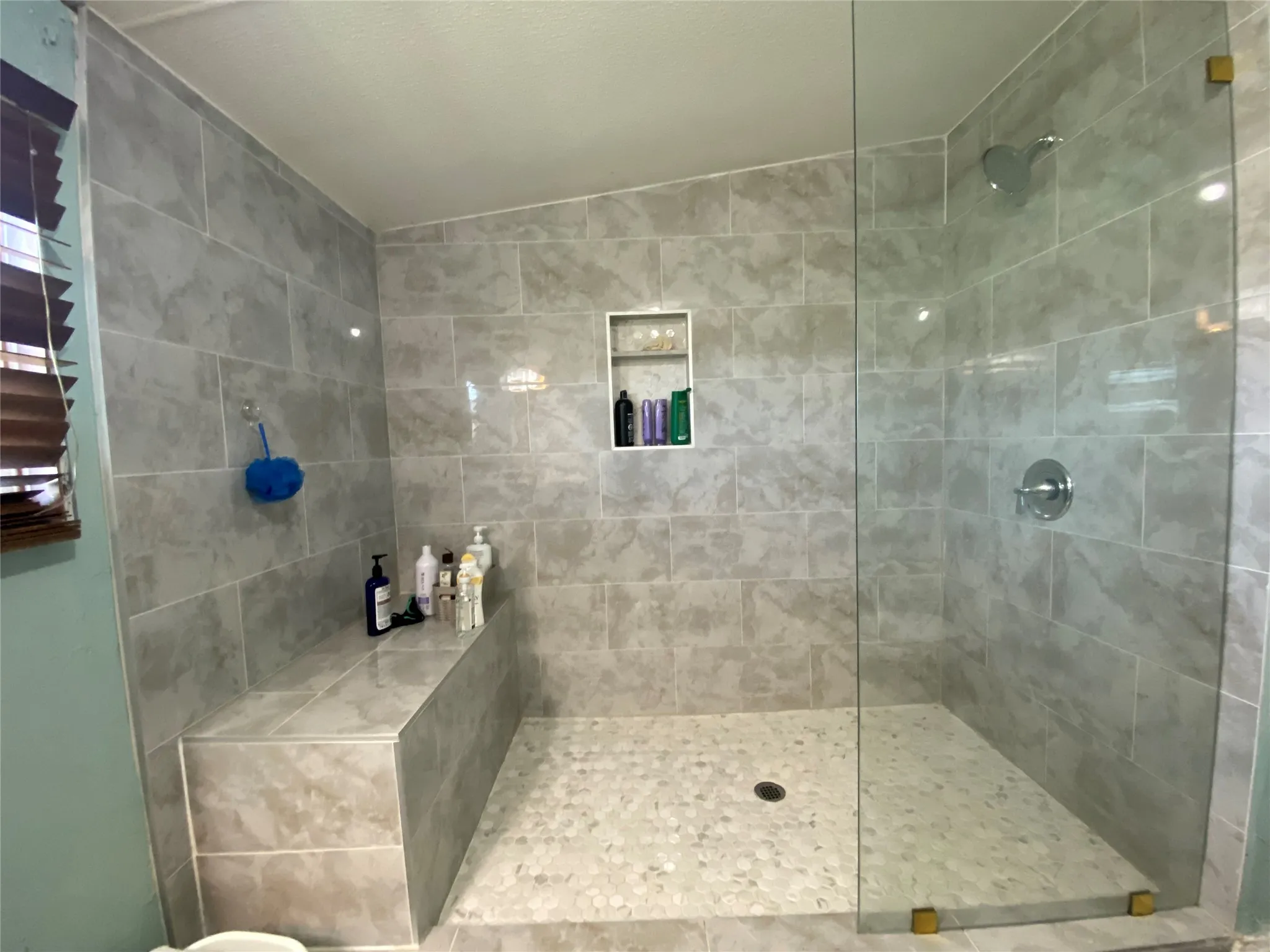 Bathroom with a walk in shower and lofted ceiling