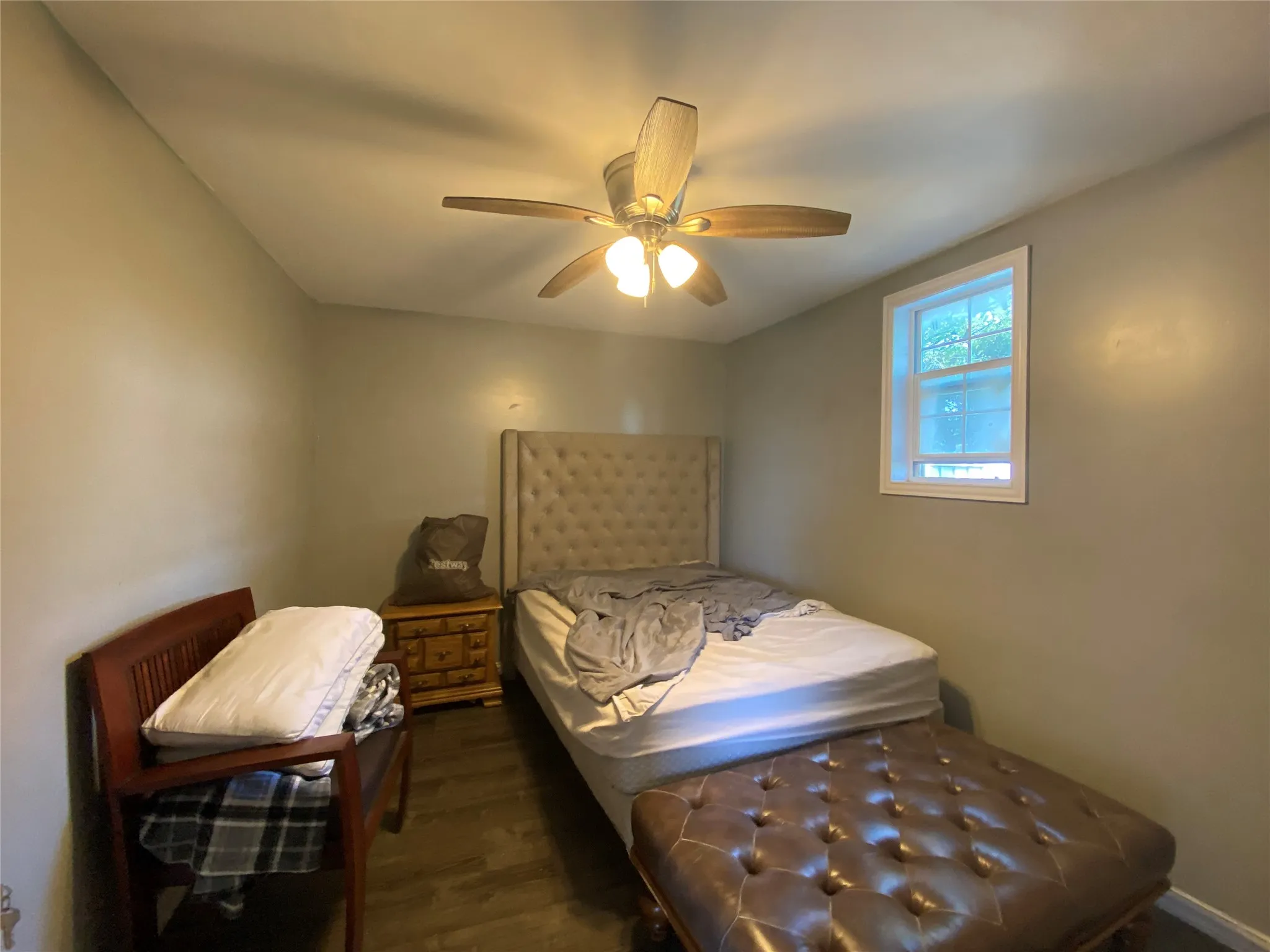 Bedroom featuring dark wood-style floors and a ceiling fan