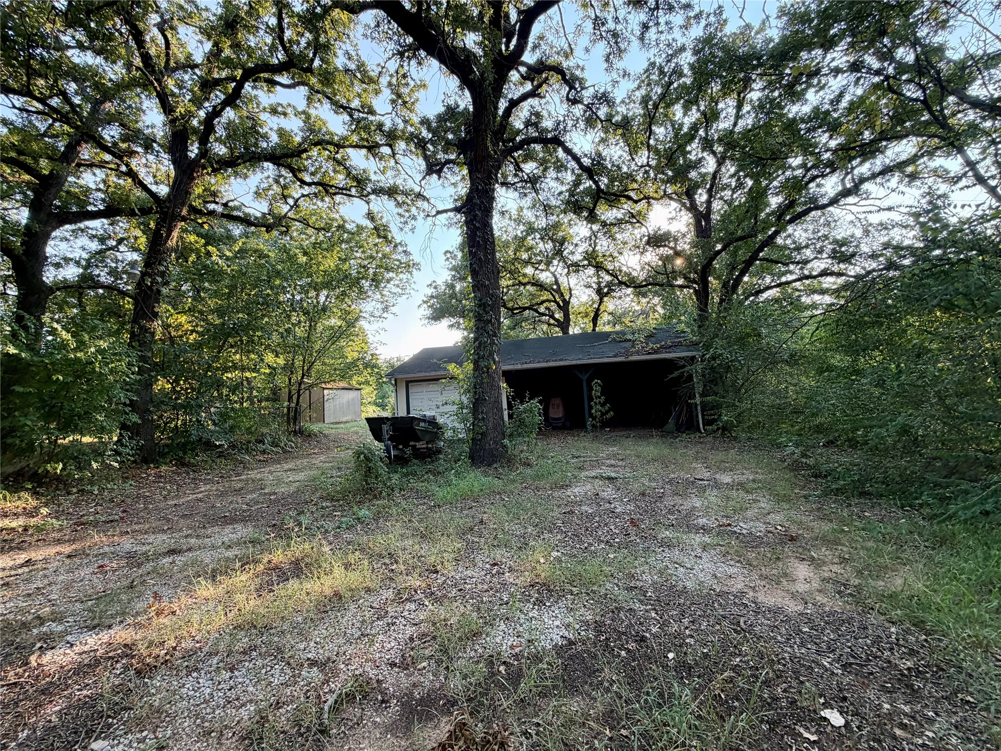 1 car garage with 2 car carport and shed