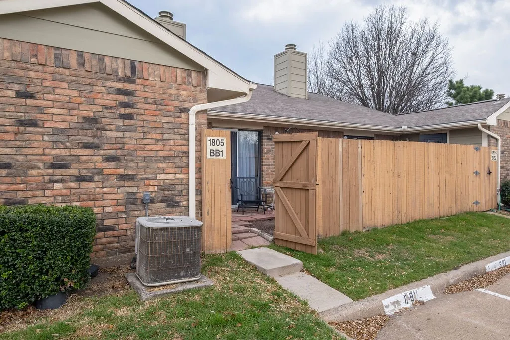 Brick exterior featuring a private fenced patio area