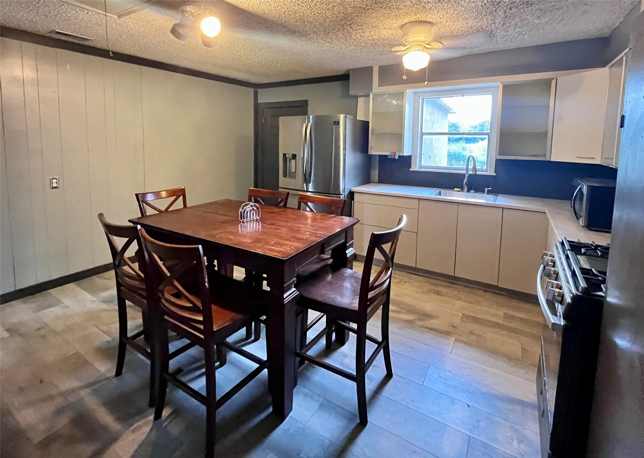 Updated IKEA cabinetry ready for your customization, stainless appliances, generous counter space, and room for everyday dining.