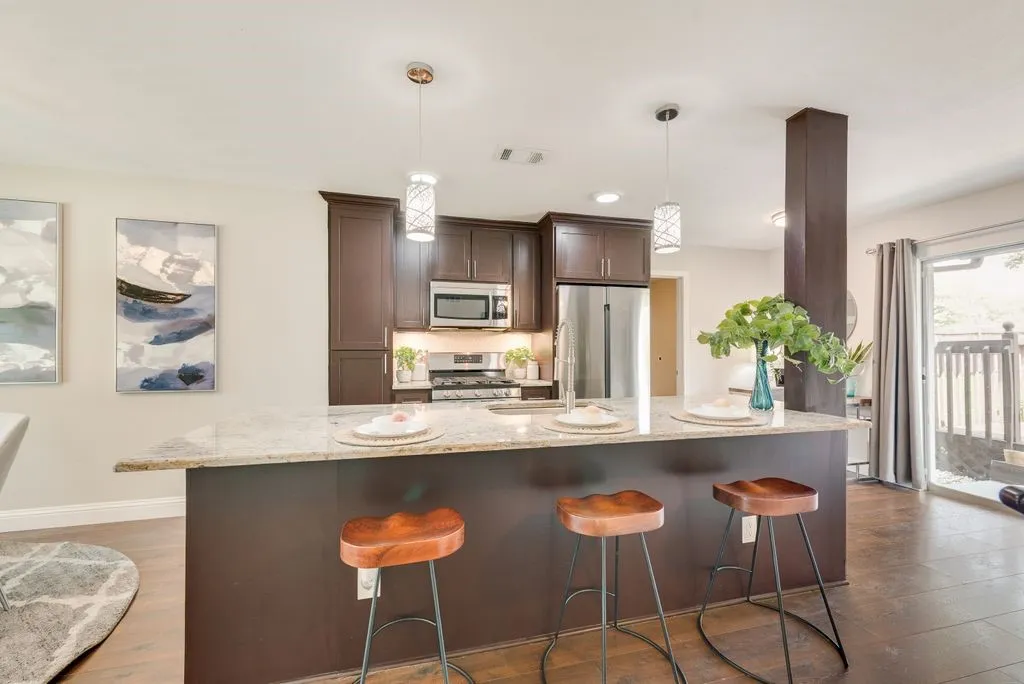Kitchen island with a granite countertop and pendant lighting