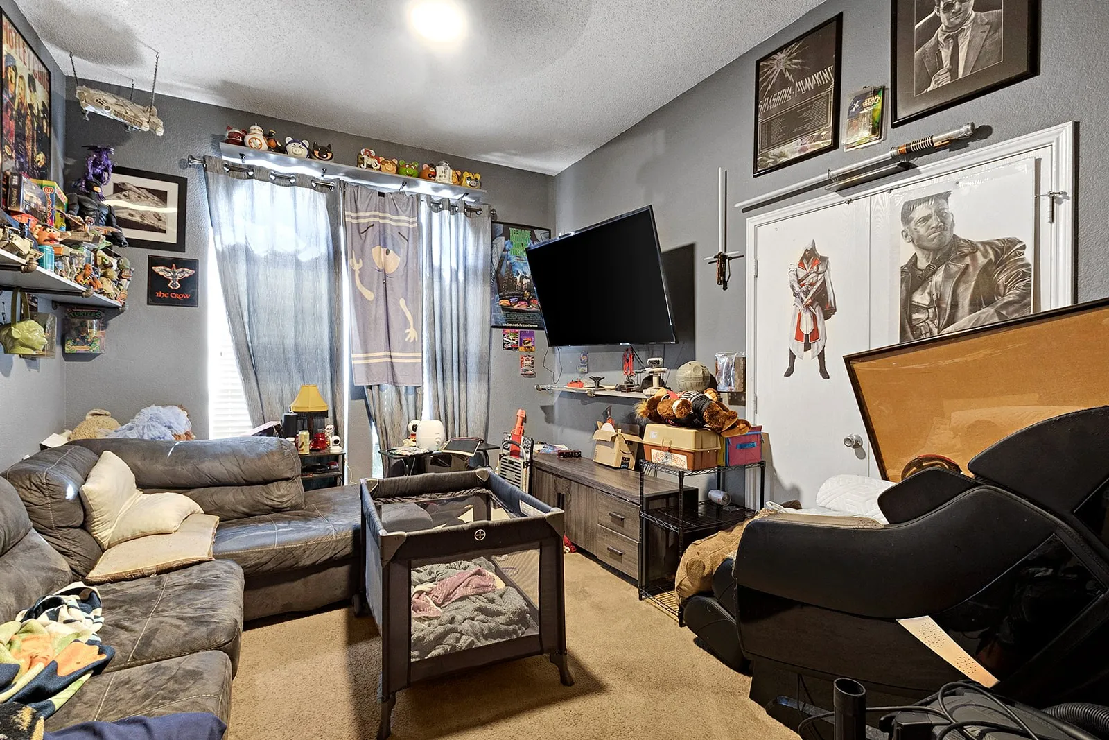 Spacious interior room with neutral gray walls and light-colored carpet flooring