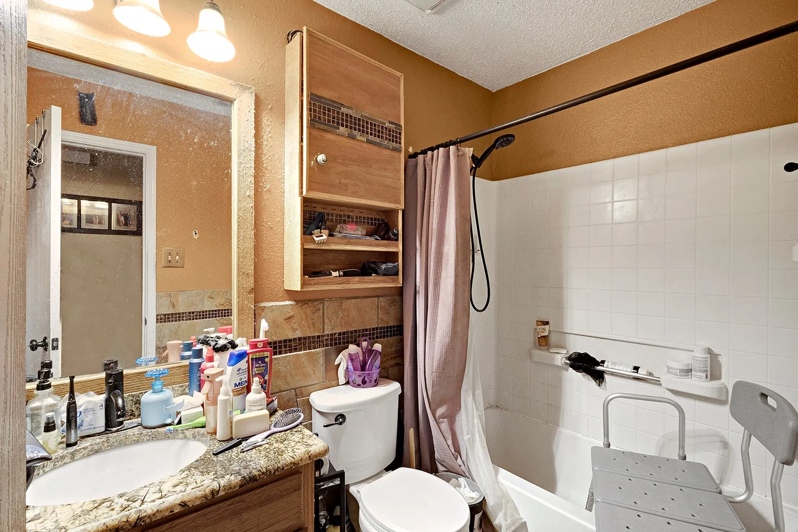 Bathroom featuring a vanity with a light-toned stone countertop and undermount sink