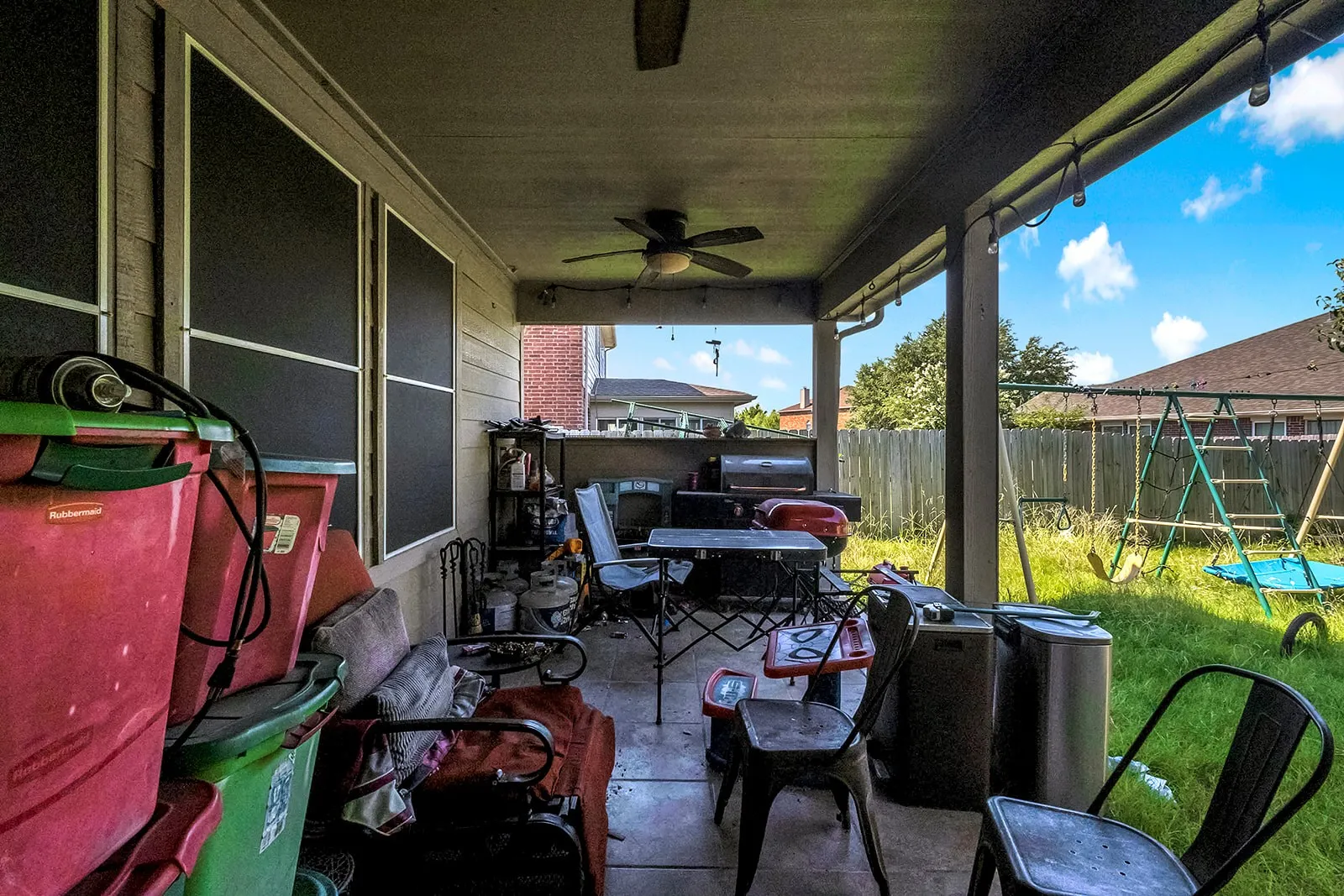 Covered patio featuring a ceiling fan, string lighting, and a paved floor