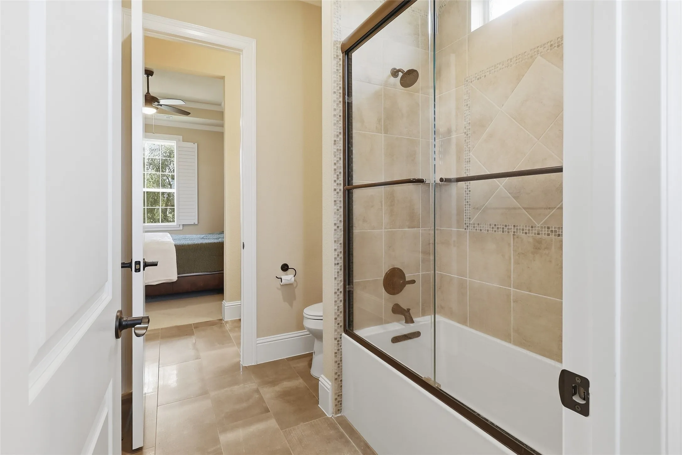 Jack 'n Jill bathroom with its glass-enclosed tub/shower combination.