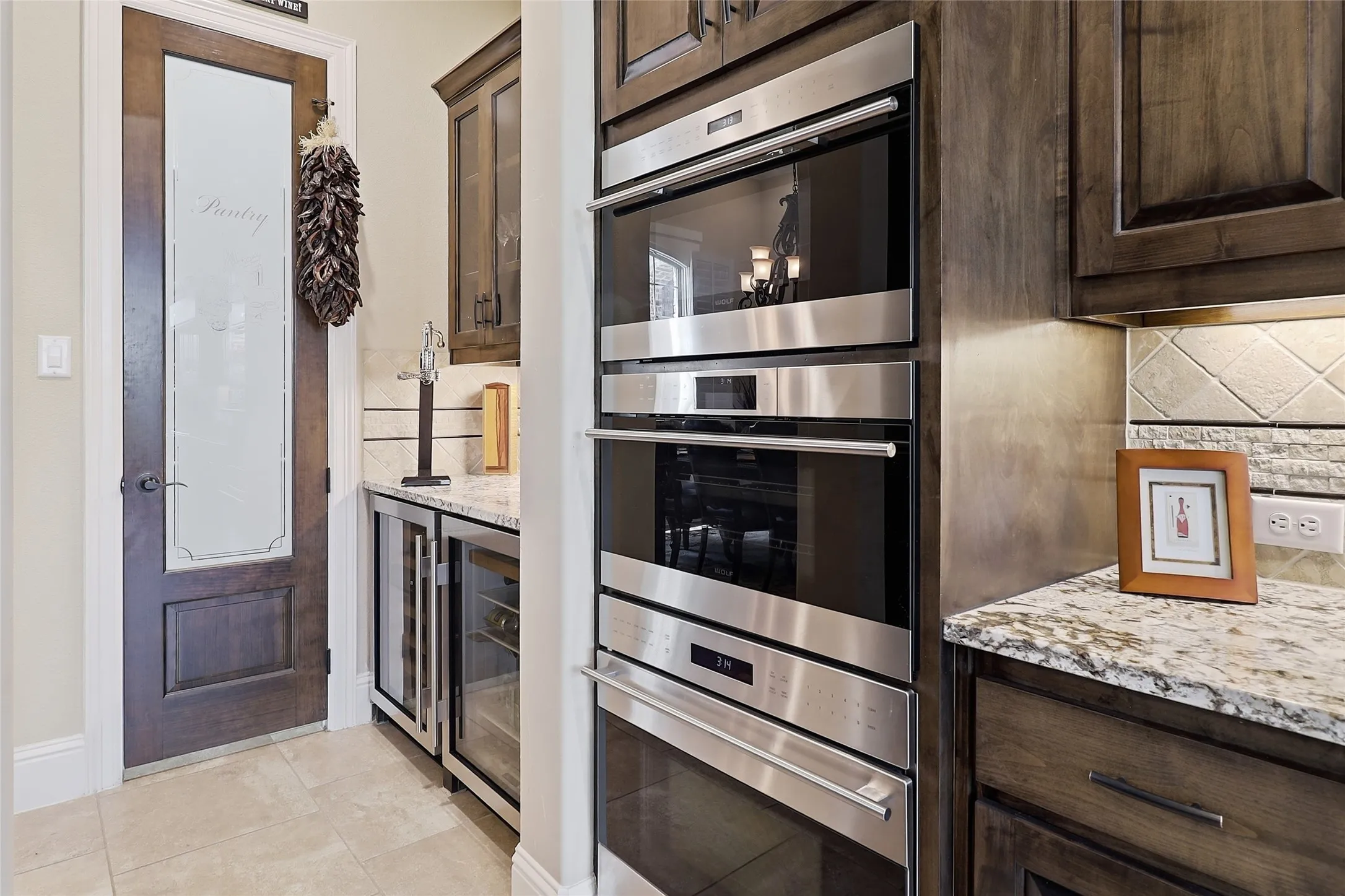 Spacious walk-in pantry with its upgraded customized glass door.