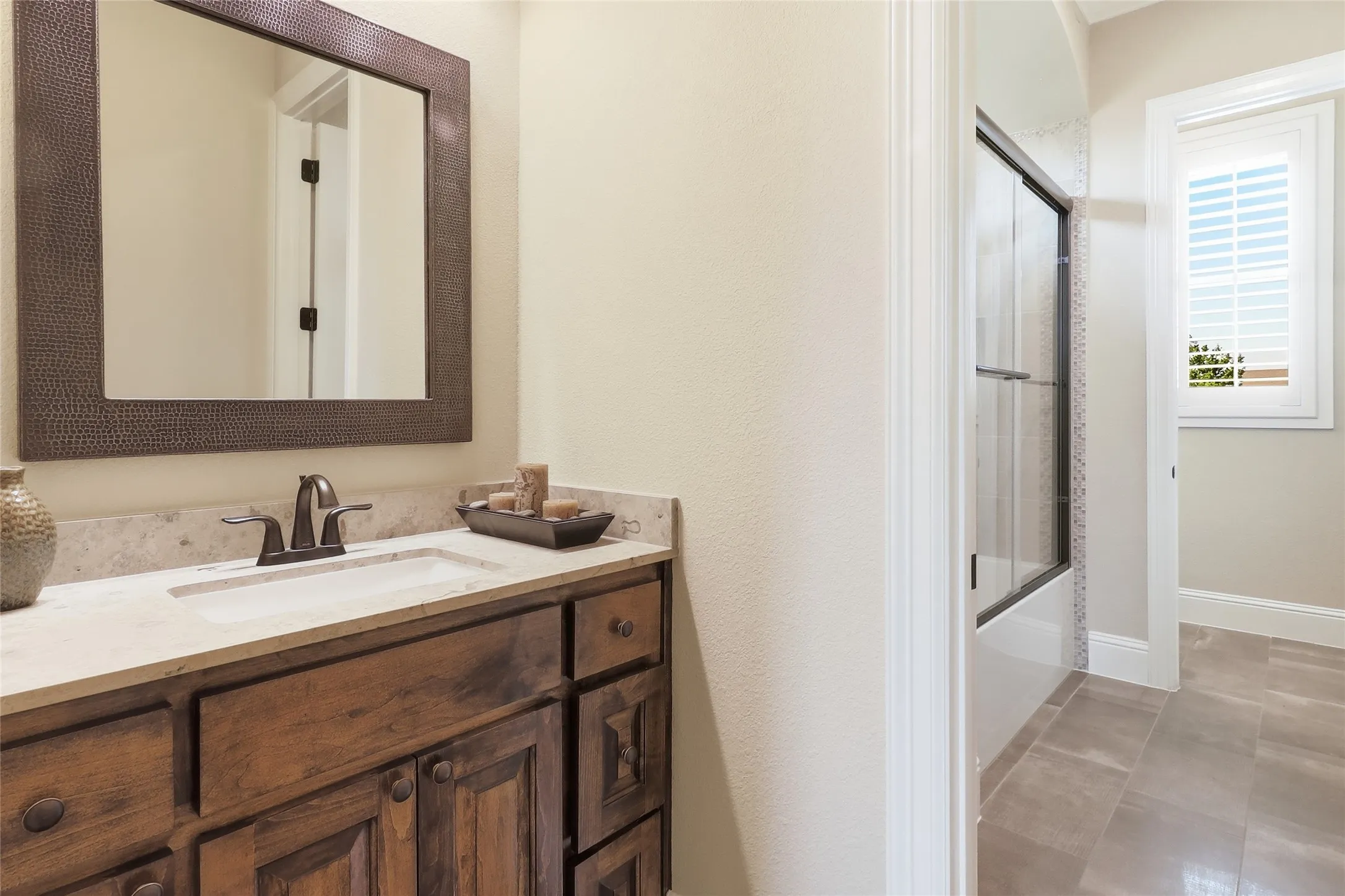 Jack 'n Jill bathroom features stunning hammered copper framed mirrors.