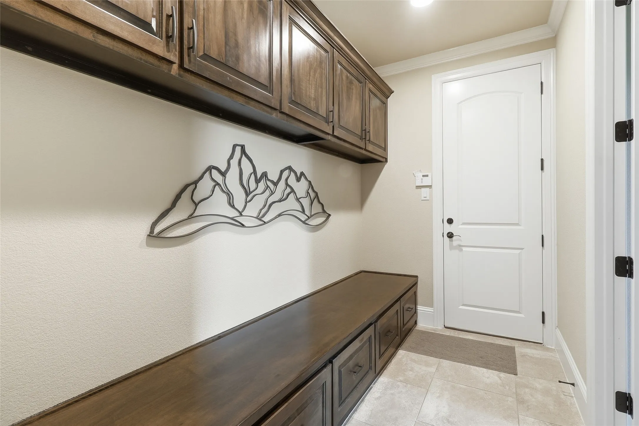 Such a perfect mud room to this gorgeous home from the garage into the home with tons of cabinet storage.
