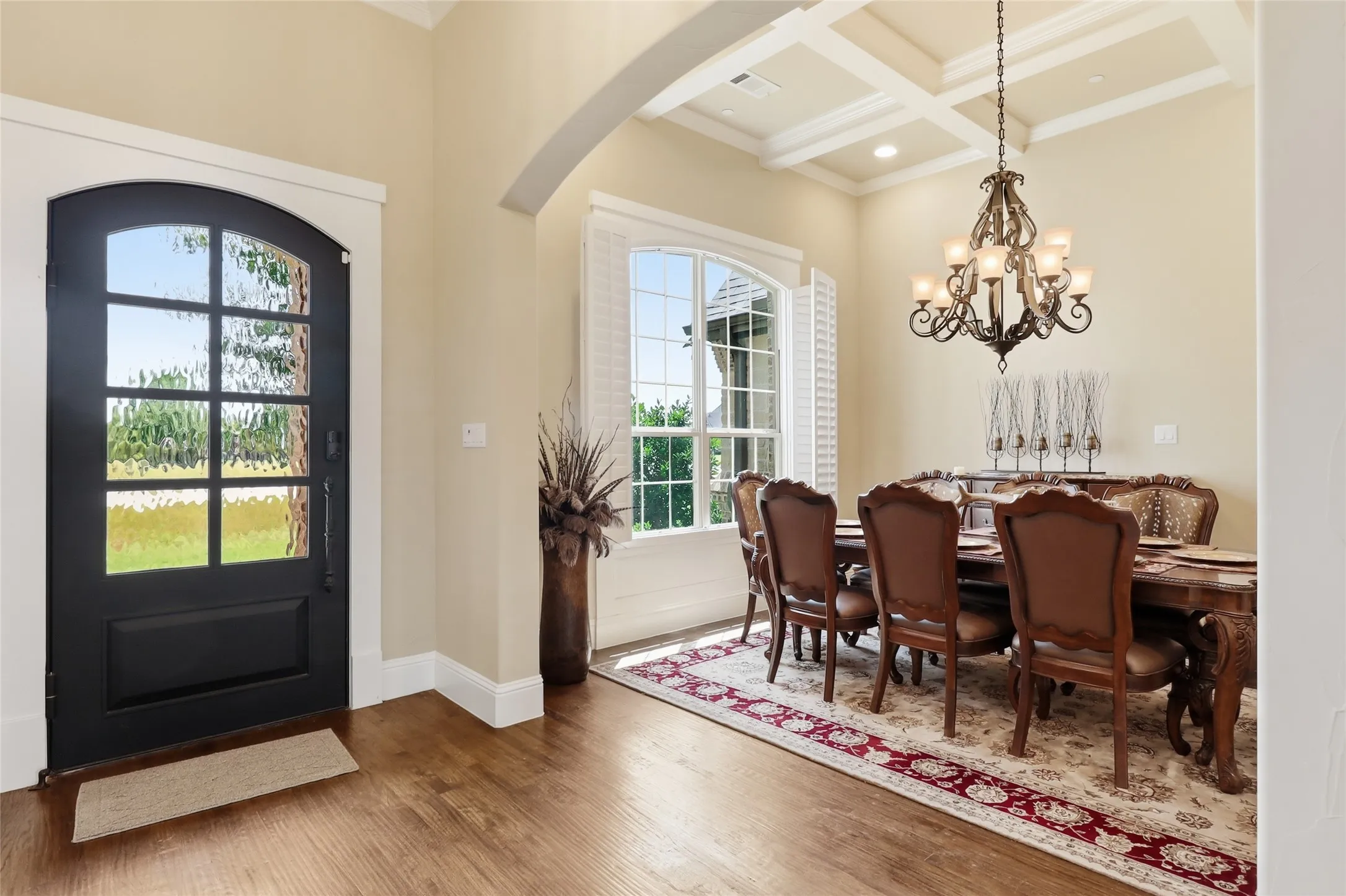 Elegant elevated entry is open to architecturally arched openings.
