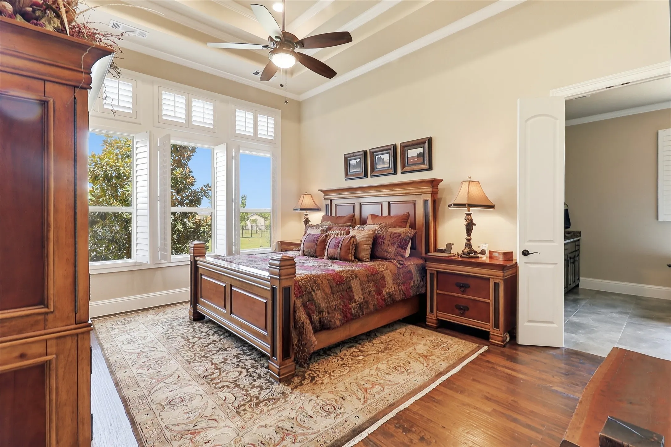 Primary Bedroom with its easy-maintenance wood flooring and wide-open view to the awesome backyard.