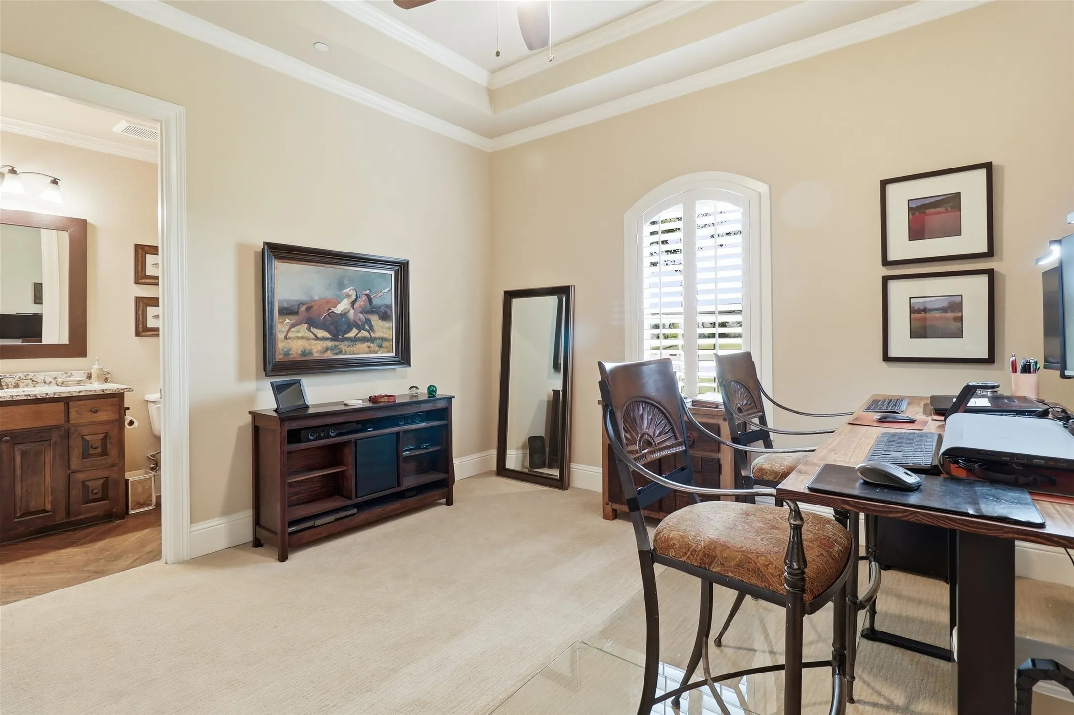 4th bedroom boasts of a private full bathroom, elevated ceiling treatment, and a view of the gorgeous front yard.