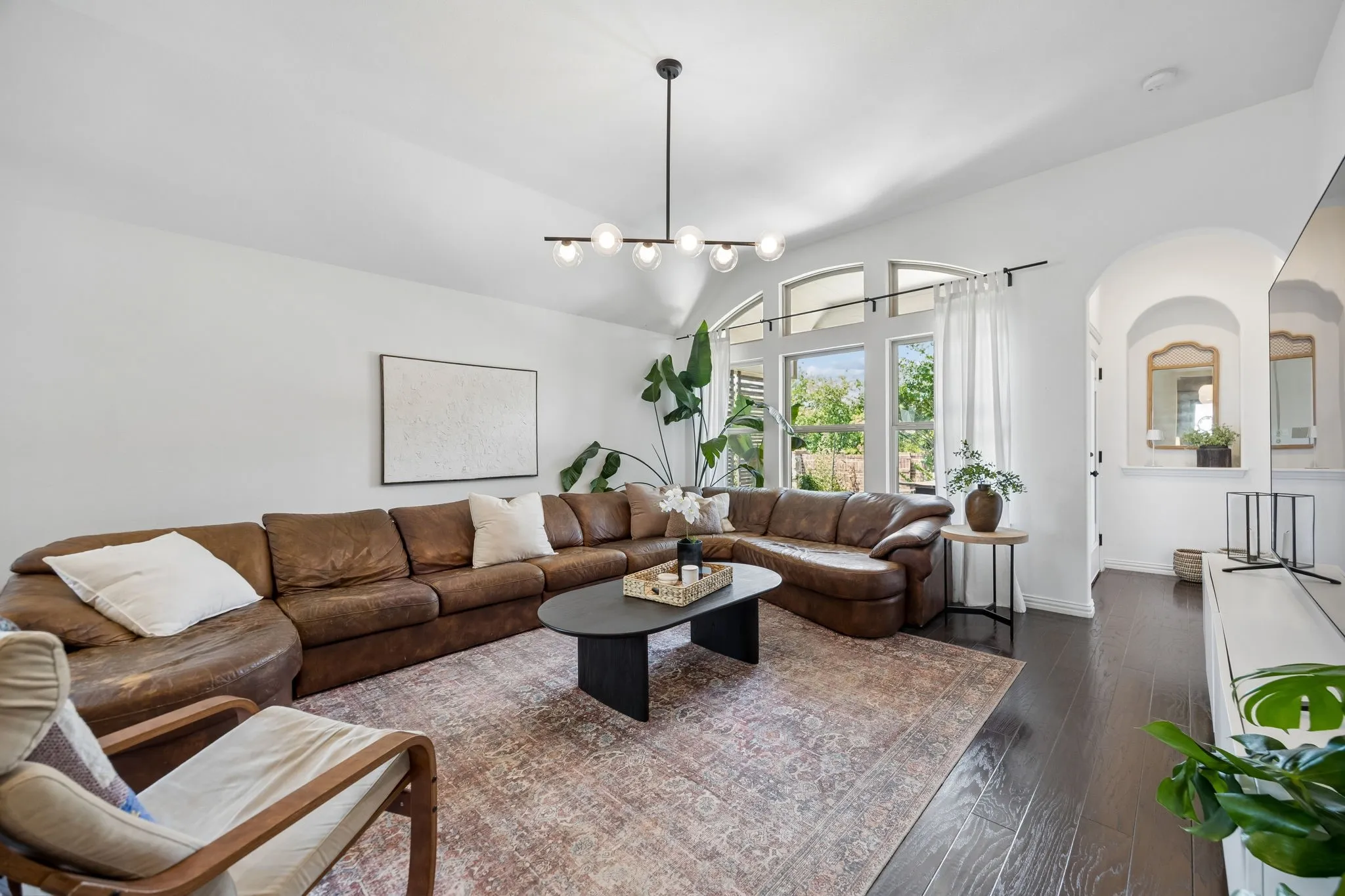I love how the living room looks out to the extended patio with lush green space.