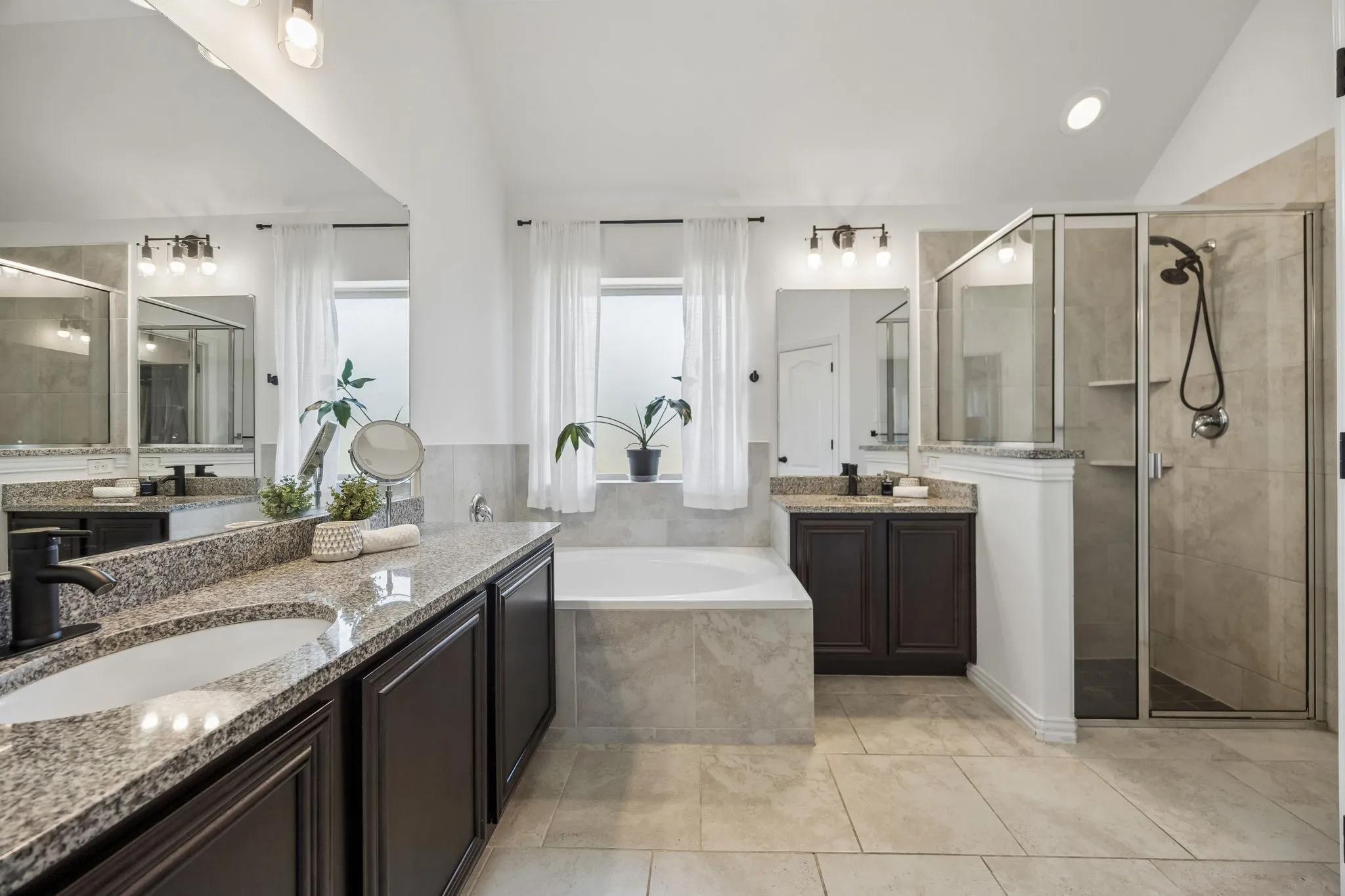 Master bath with separate shower and tub and 2 separate vanities