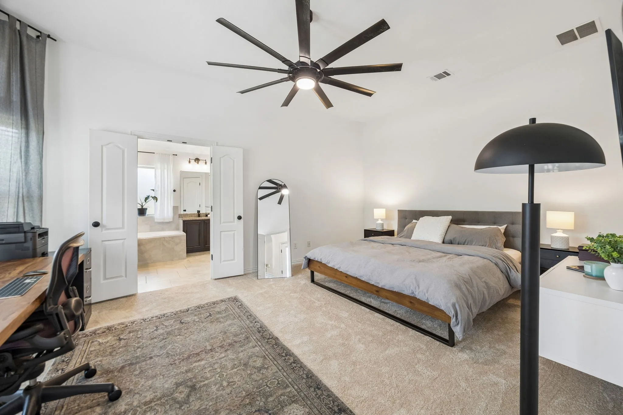 Primary bedroom with King bed, 2 side tables AND an additional workspace in front of the bay windows.