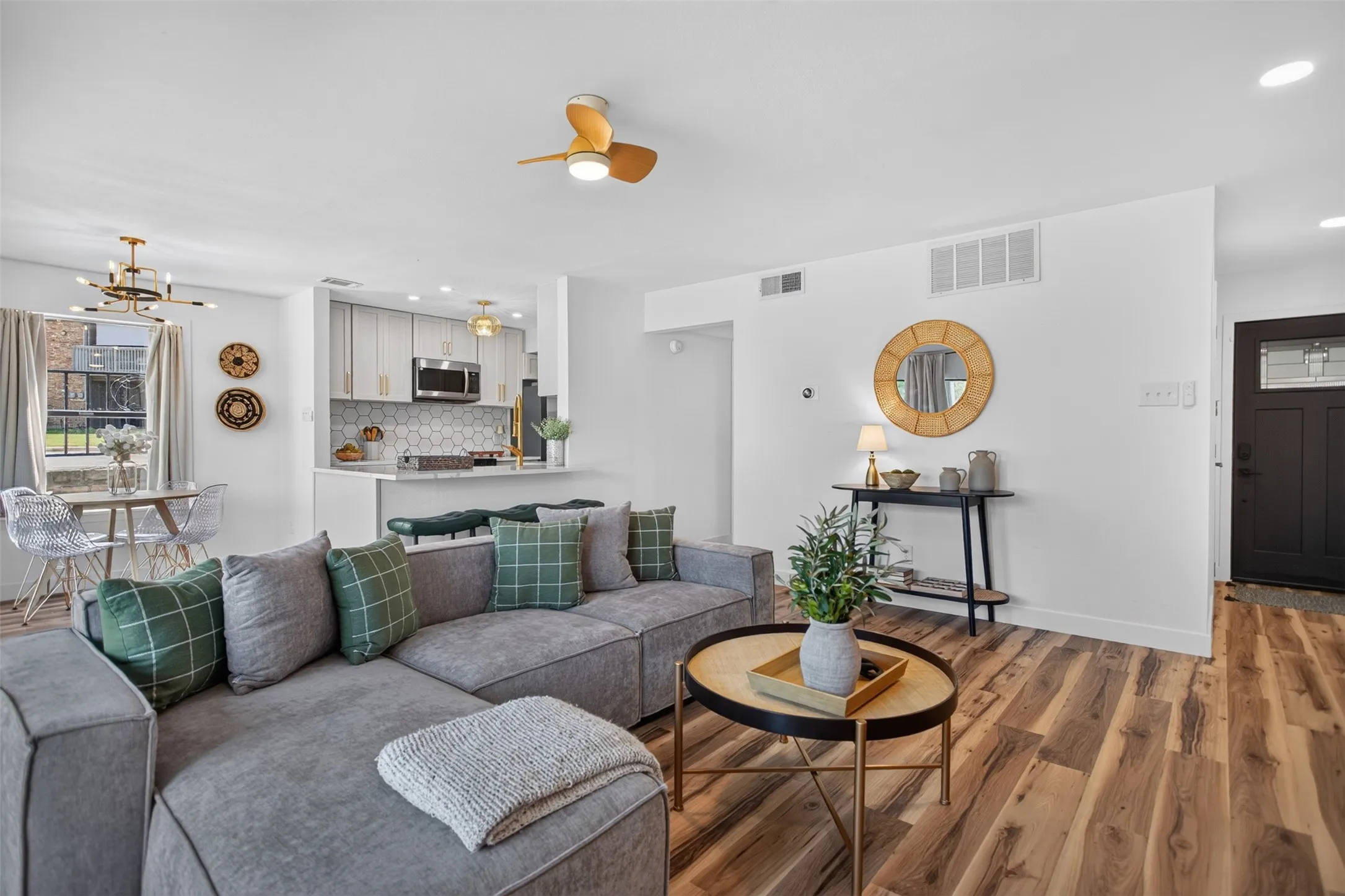 Front door walking in to living area featuring wood-finish flooring, a contemporary ceiling fan, and recessed lighting