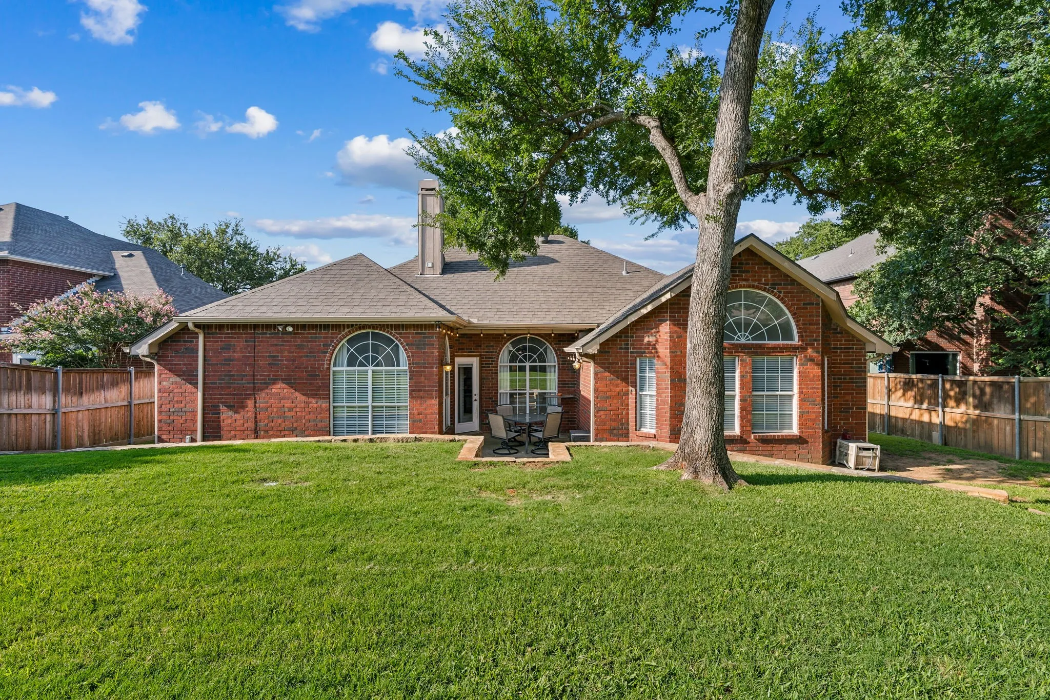 Backyard view with mature trees.