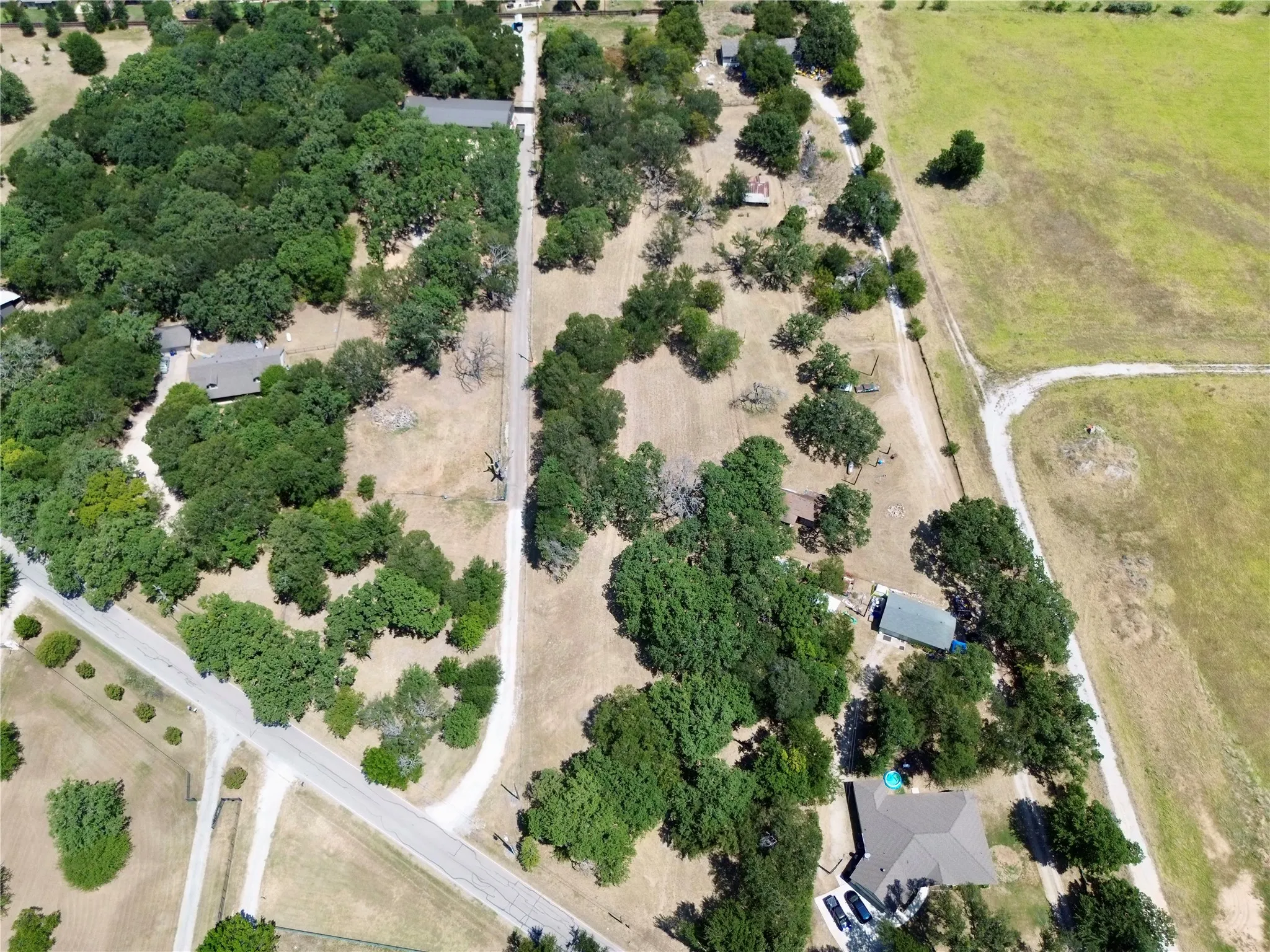 Expansive aerial perspective showcasing a property surrounded by mature trees