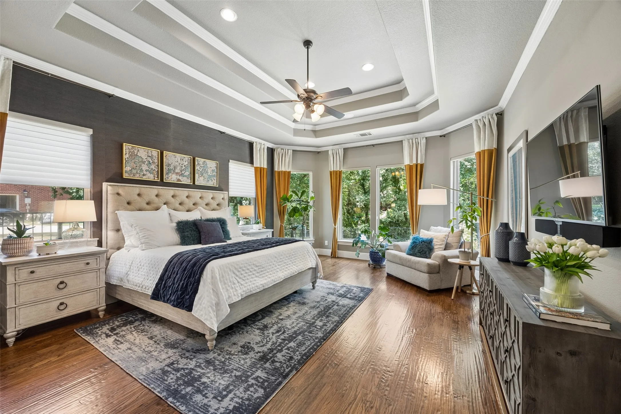 Hardwood flooring and tray ceiling with recessed lighting