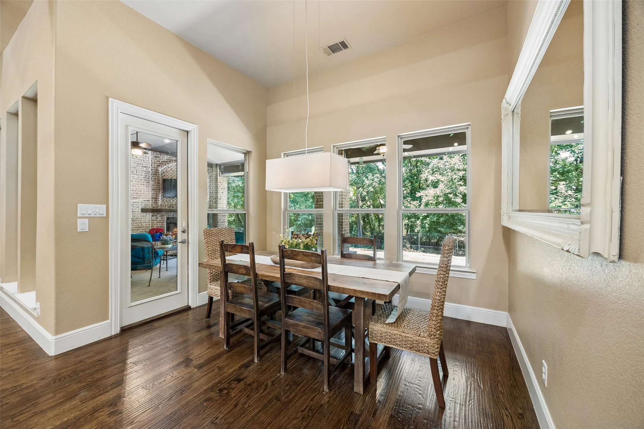 Dining area with wood-finish flooring and neutral wall tones