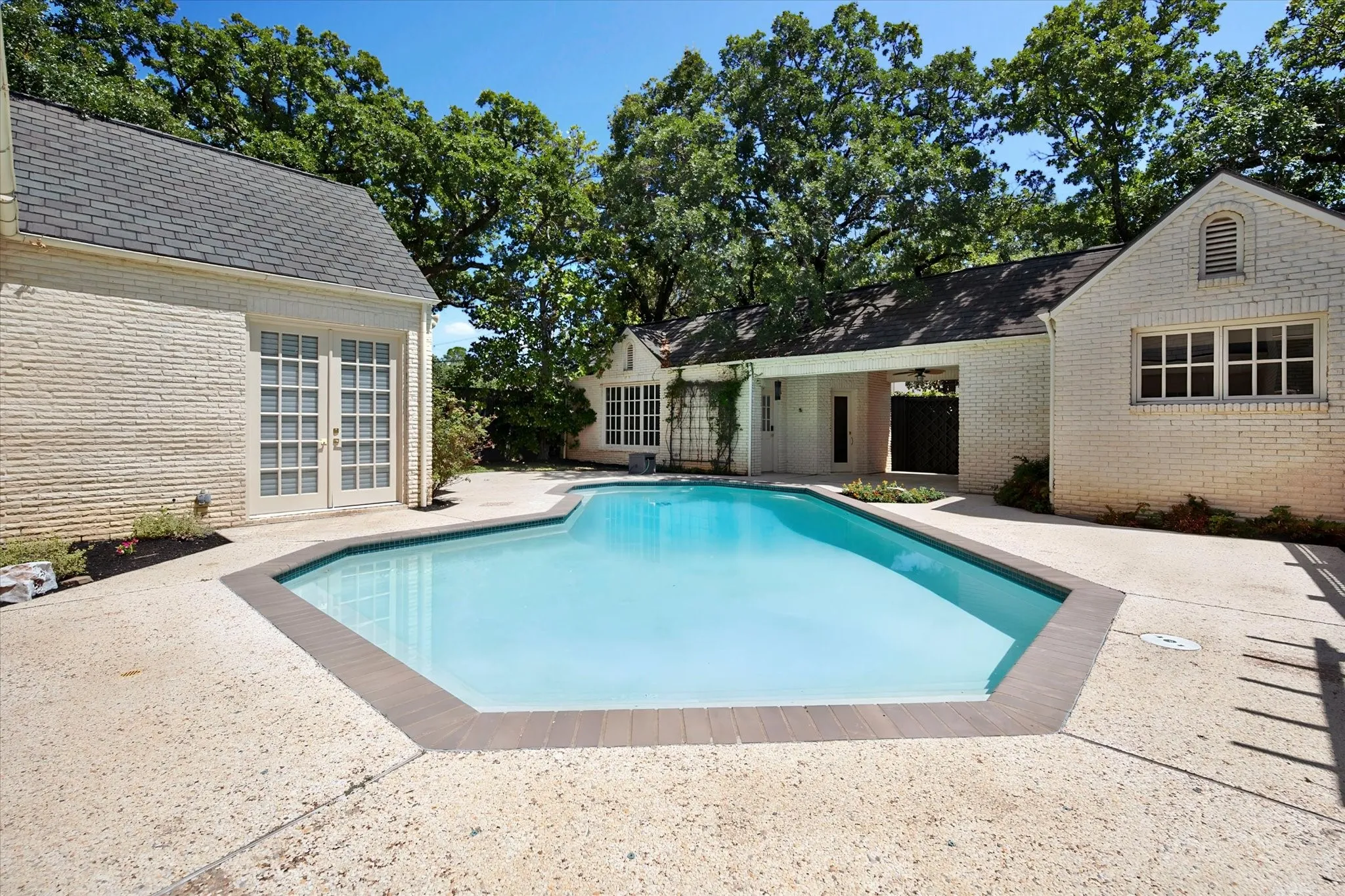 Left side is detached guest quarters or pool house and sauna, right side is climate controlled 3rd garage with separate washer/dryer connections.