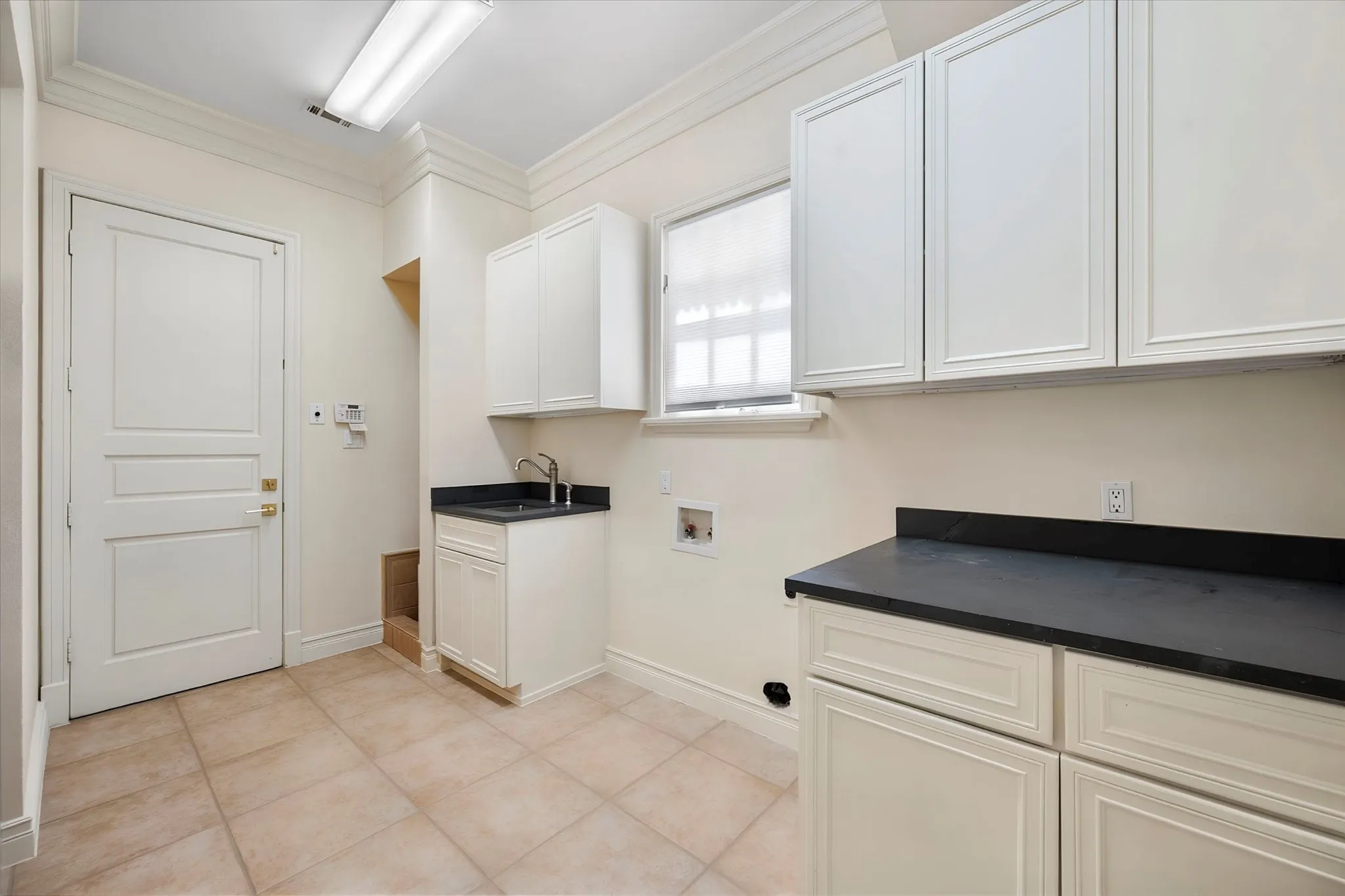 Large utility room with sink, room for freezer