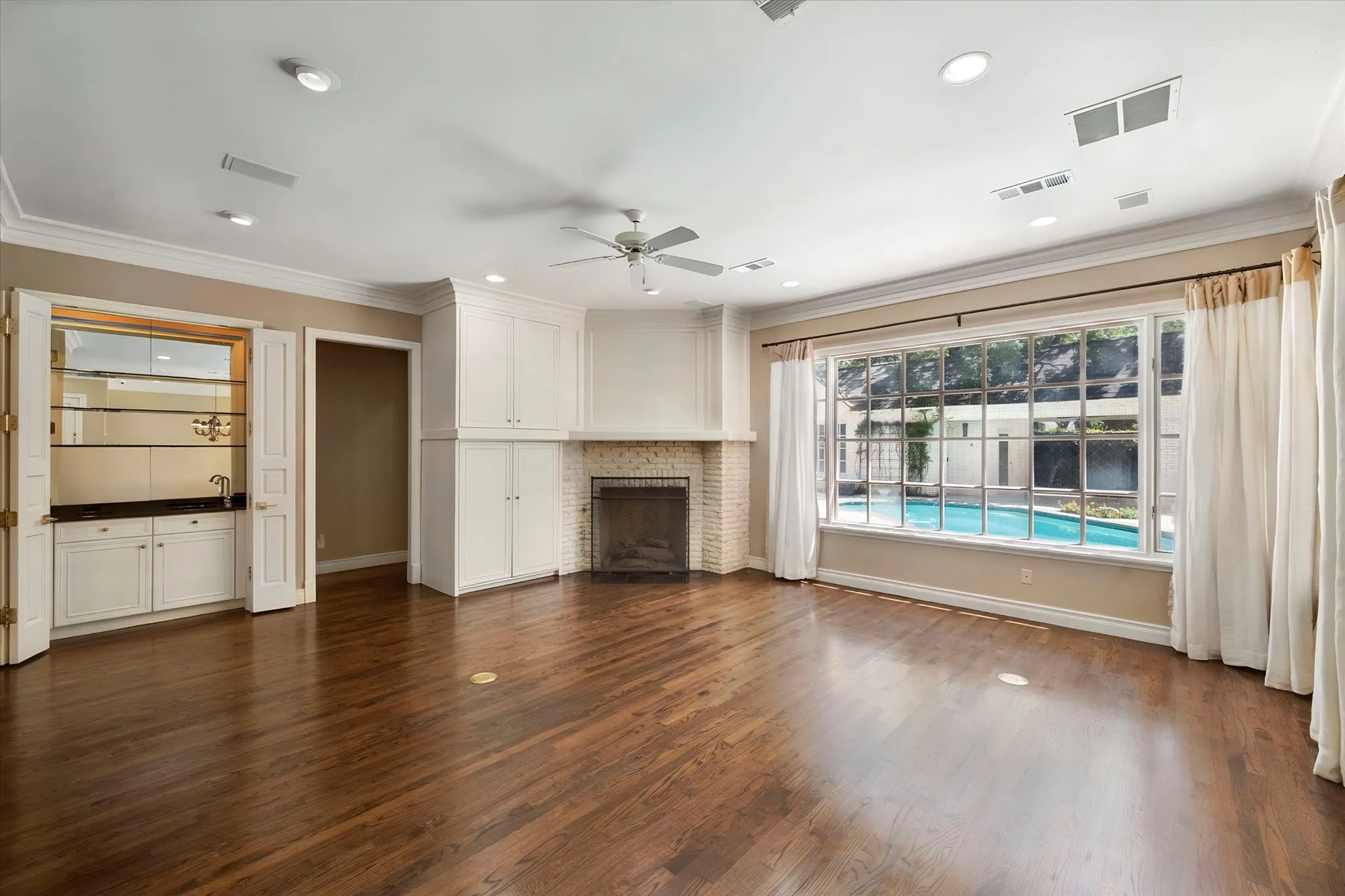 The family room is designed for entertaining and relaxing with its fireplace and wet bar.