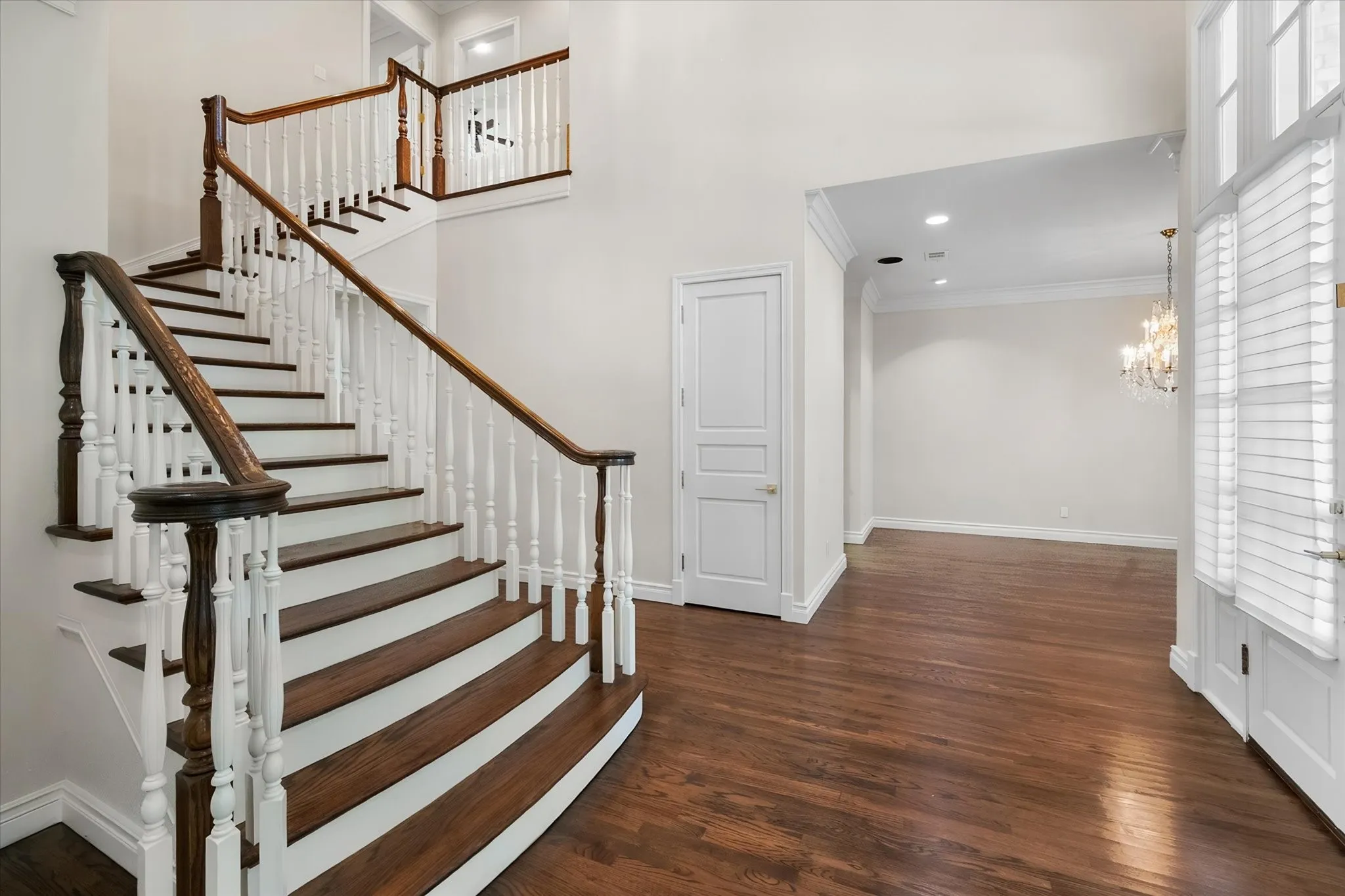 The spacious entry has a soaring ceiling and a formal dining to the right.